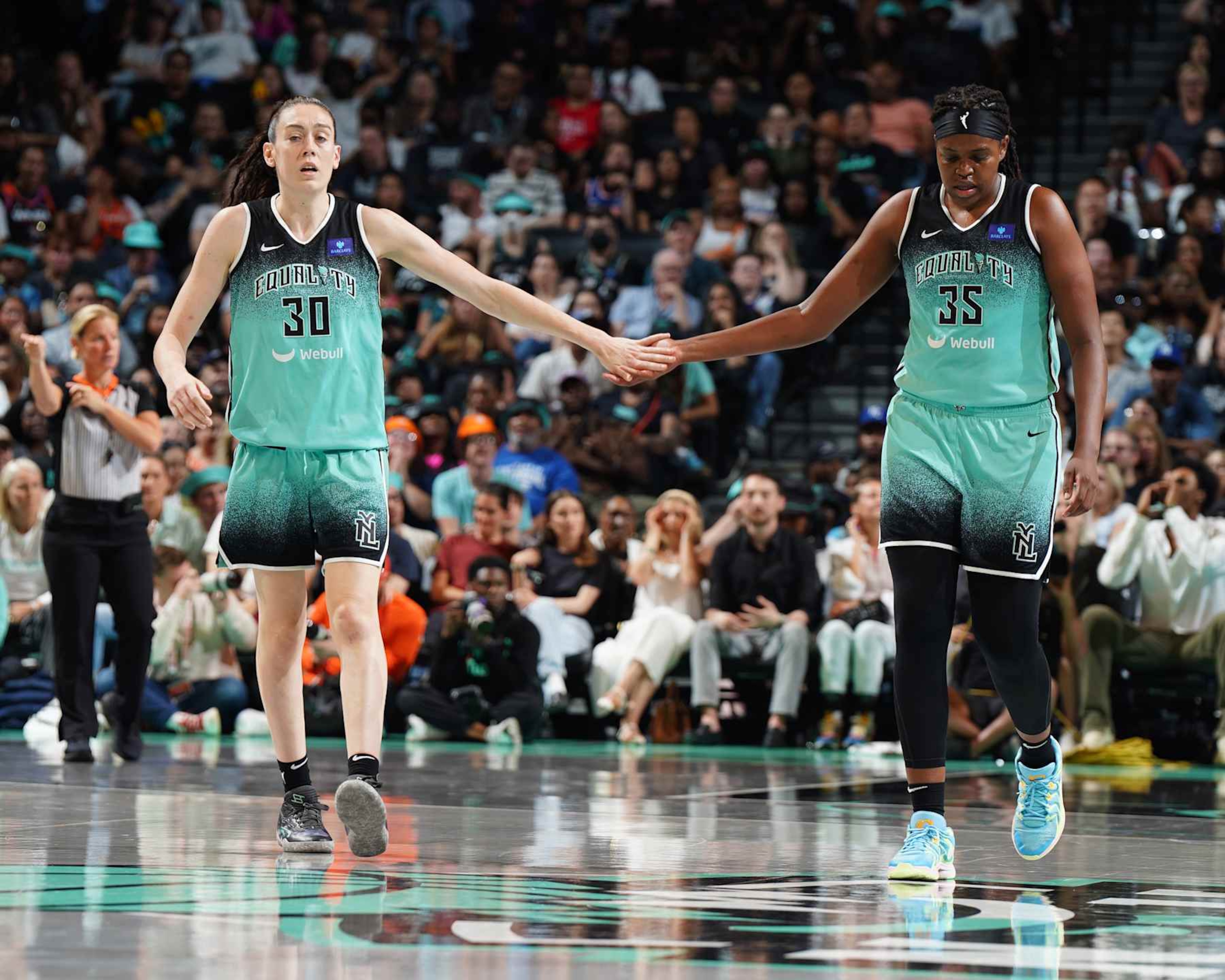 BROOKLYN, NY - AUGUST 24: Breanna Stewart #30 and Jonquel Jones #35 of the New York Liberty high fives during the game on August 24, 2024 at the Barclays Center in Brooklyn, New York. NOTE TO USER: User expressly acknowledges and agrees that, by downloading and or using this photograph, user is consenting to the terms and conditions of the Getty Images License Agreement. Mandatory Copyright Notice: Copyright 2023 NBAE (Photo by Catalina Fragoso/NBAE via Getty Images) BROOKLYN, NY - AUGUST 24: Breanna Stewart #30 and Jonquel Jones #35 of the New York Liberty high fives during the game on August 24, 2024 at the Barclays Center in Brooklyn, New York. NOTE TO USER: User expressly acknowledges and agrees that, by downloading and or using this photograph, user is consenting to the terms and conditions of the Getty Images License Agreement. Mandatory Copyright Notice: Copyright 2023 NBAE (Photo by Catalina Fragoso/NBAE via Getty Images)