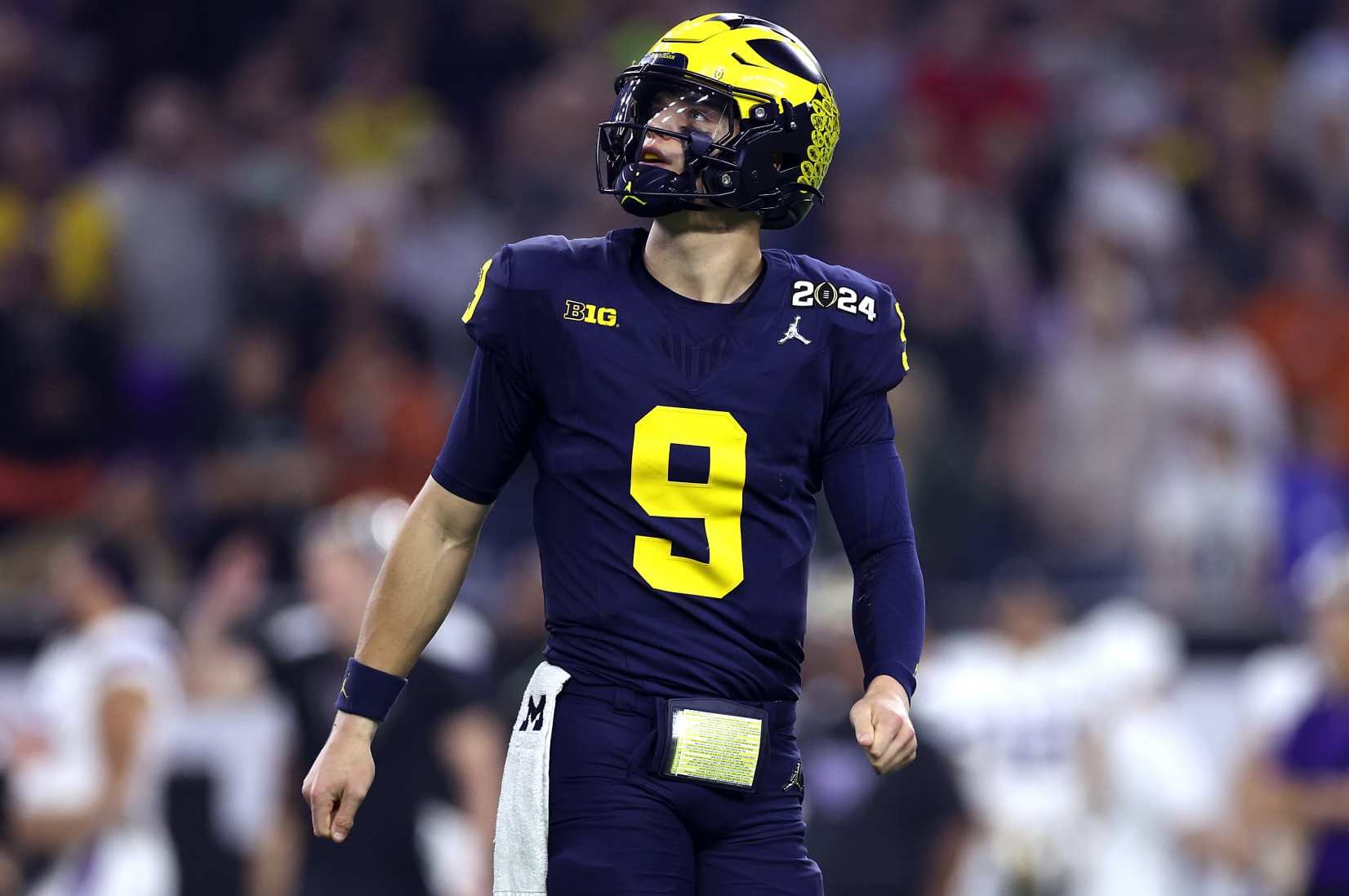 HOUSTON, TEXAS - JANUARY 08: J.J. McCarthy #9 of the Michigan Wolverines looks on in the first half against the Washington Huskies during the 2024 CFP National Championship game at NRG Stadium on January 08, 2024 in Houston, Texas. (Photo by Maddie Meyer/Getty Images)