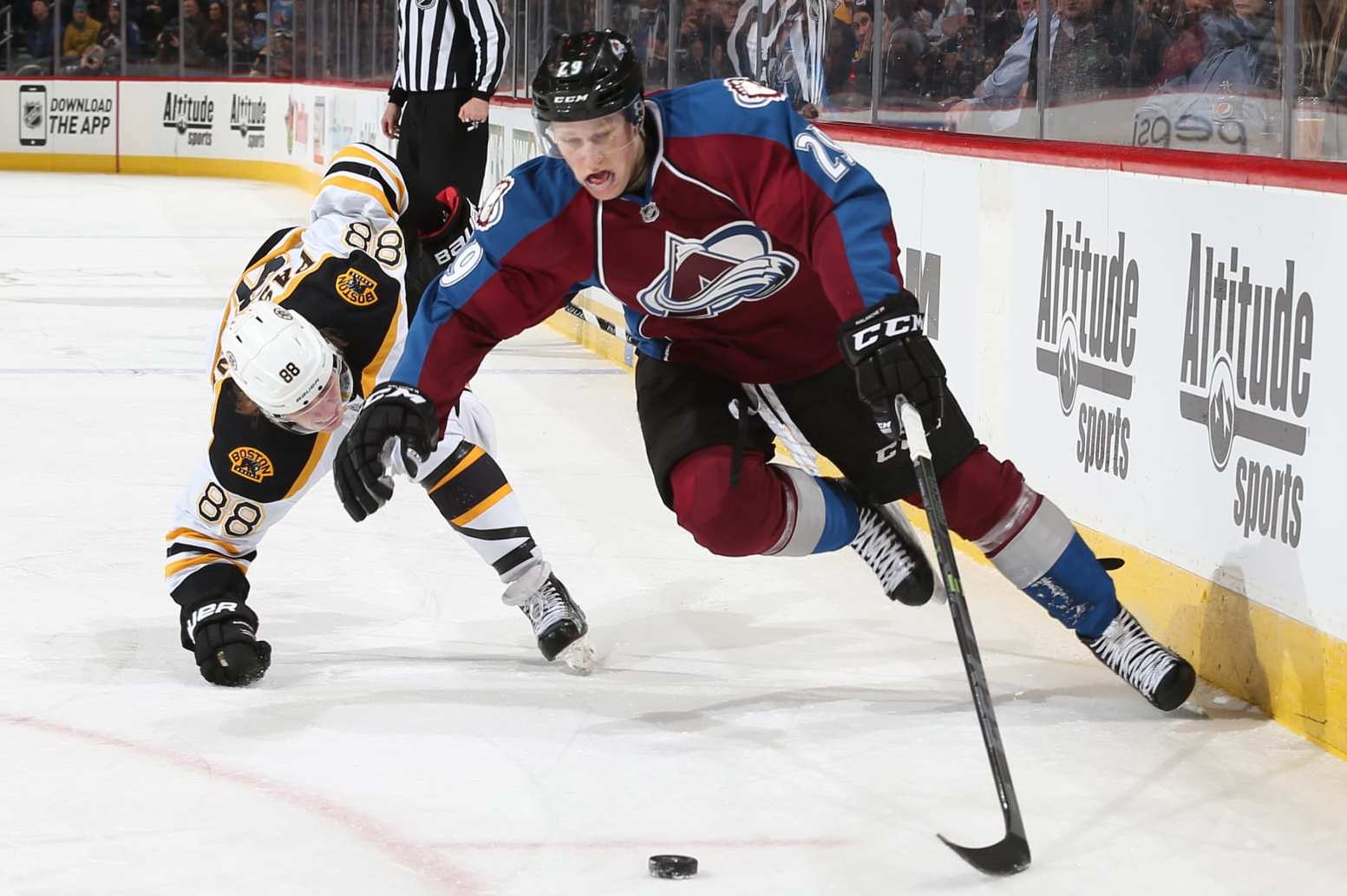 DENVER, CO - JANUARY 21: Nathan MacKinnon #29 of the Colorado Avalanche skates with the puck as he is challenged by David Pastrnak #88 of the Boston Bruins at the Pepsi Center on January 21, 2015 in Denver, Colorado. (Photo by Michael Martin/NHLI via Getty Images)
