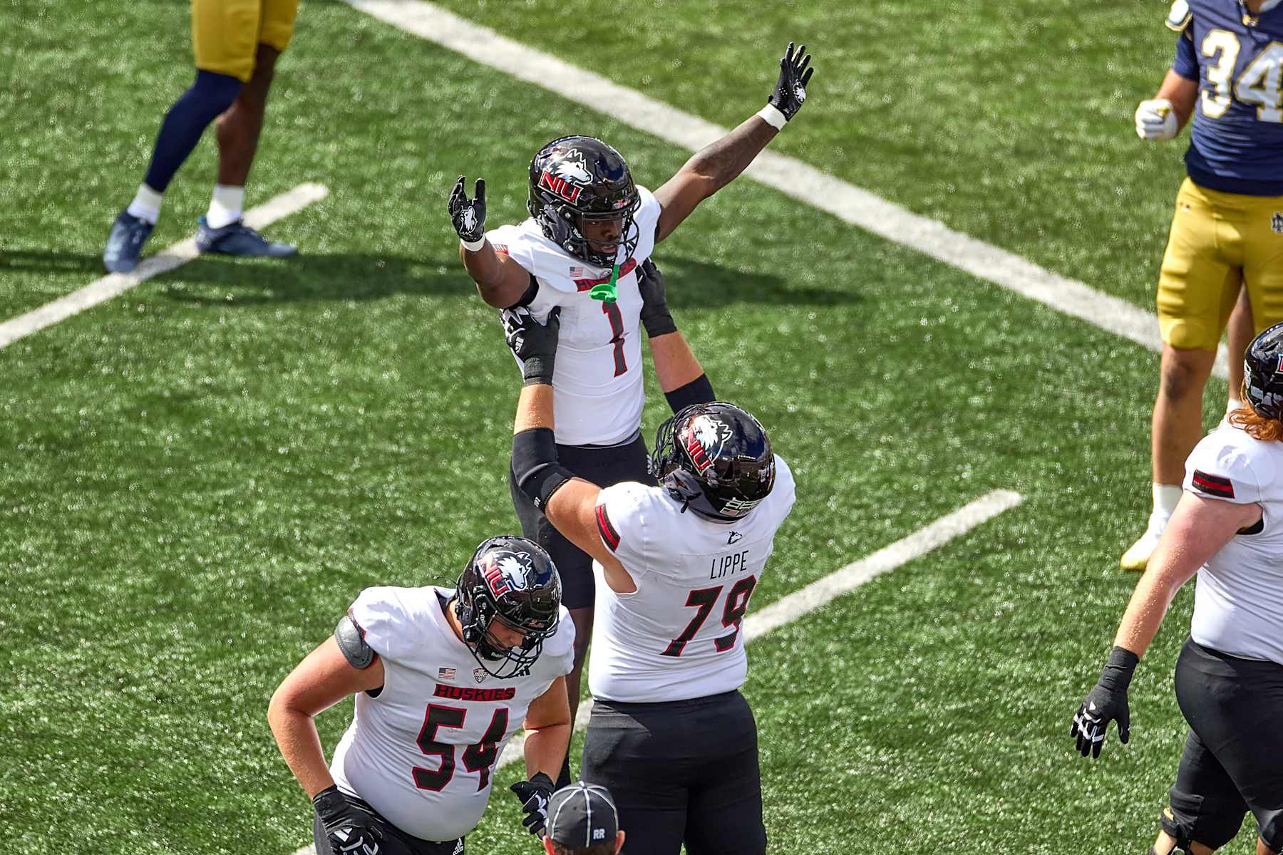 SOUTH BEND, IN - SEPTEMBER 07: Northern Illinois Huskies running back Antario Brown (1) celebrates with Northern Illinois Huskies offensive lineman J.J. Lippe (79) after scoring a touchdown in action during a game between the Northern Illinois Huskies the Notre Dame Fighting Irish on September 7, 2024, at Notre Dame Stadium in South Bend, IN. (Photo by Robin Alam/Icon Sportswire via Getty Images)