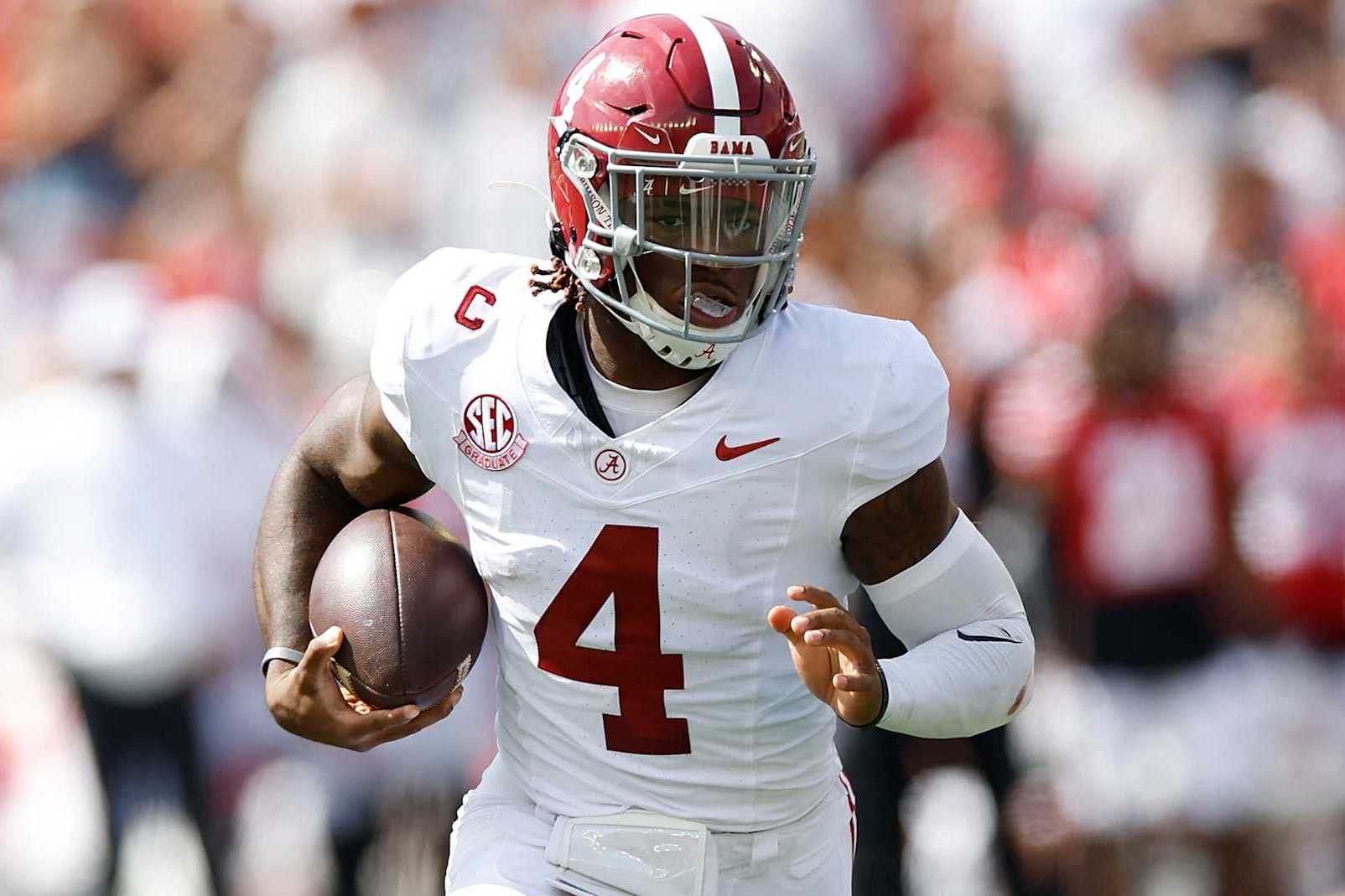 MADISON, WISCONSIN - SEPTEMBER 14: Jalen Milroe #4 of the Alabama Crimson Tide carries the ball in the first quarter against the Wisconsin Badgers at Camp Randall Stadium on September 14, 2024 in Madison, Wisconsin. (Photo by John Fisher/Getty Images)