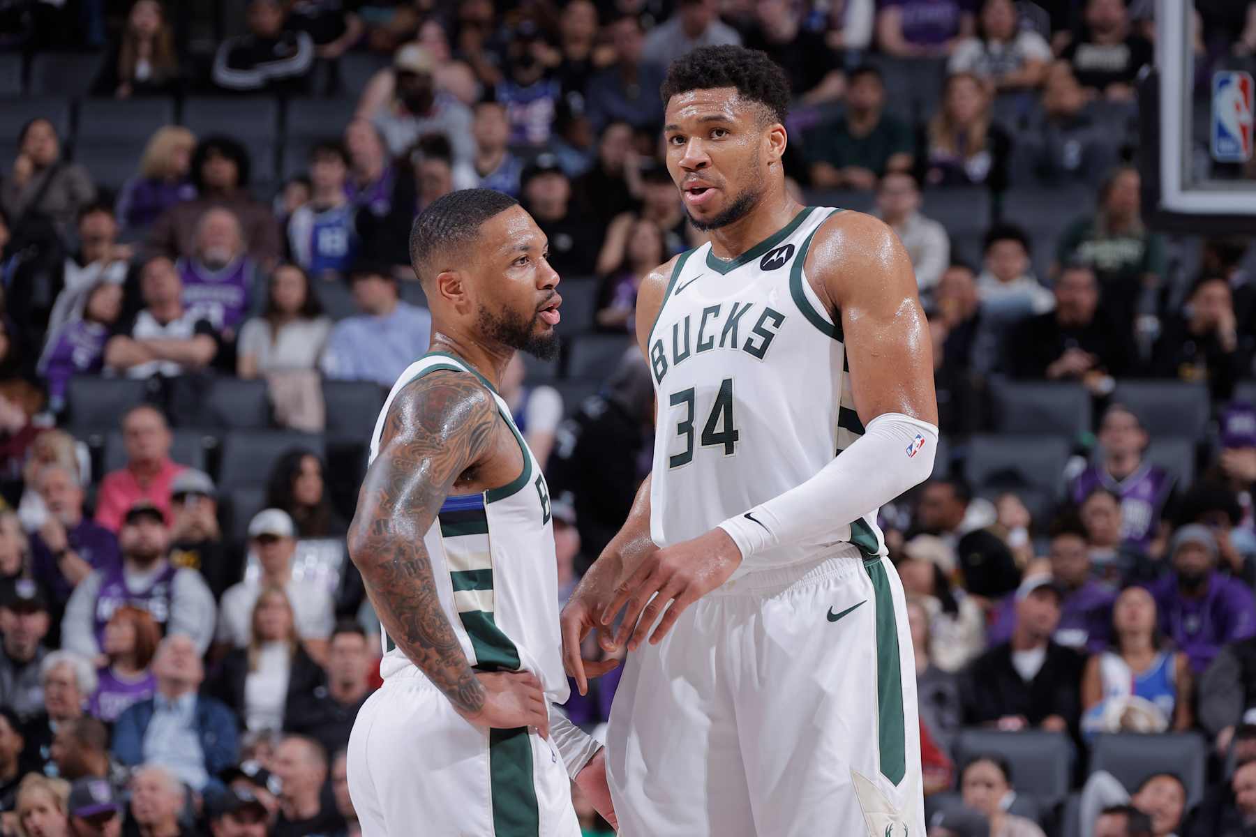 SACRAMENTO, CA - MARCH 12: Giannis Antetokounmpo #34 and Damian Lillard #0 of the Milwaukee Bucks talk during the game against the Sacramento Kings on March 12, 2024 at Golden 1 Center in Sacramento, California. NOTE TO USER: User expressly acknowledges and agrees that, by downloading and or using this photograph, User is consenting to the terms and conditions of the Getty Images Agreement. Mandatory Copyright Notice: Copyright 2024 NBAE (Photo by Rocky Widner/NBAE via Getty Images)