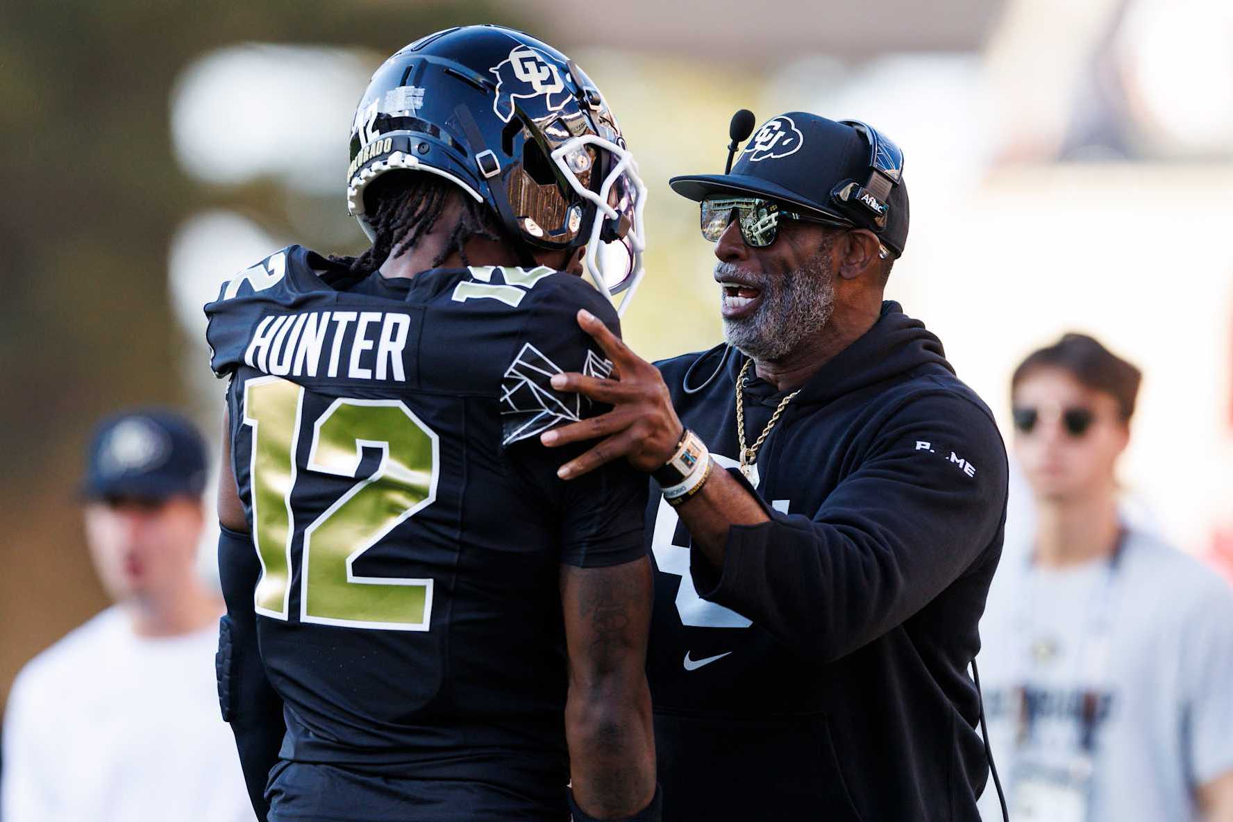 BOULDER, COLORADO - AUGUST 29: Deion Sanders of the Colorado Buffaloes and Travis Hunter #12 of the Colorado Buffaloes  on the sideline during a game against North Dakota State Bison at Folsom Field on August 29, 2024 in Boulder, Colorado. (Photo by Ric Tapia/Getty Images)