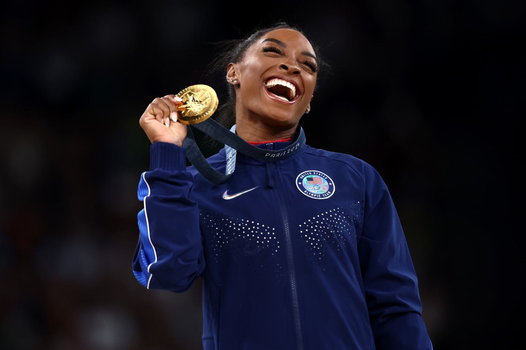 PARIS, FRANCE - AUGUST 03: Gold medalist Simone Biles of Team United States celebrates on the podium during the medal ceremony for the Artistic Gymnastics Women's Vault Final on day eight of the Olympic Games Paris 2024 at Bercy Arena on August 03, 2024 in Paris, France. (Photo by Naomi Baker/Getty Images)