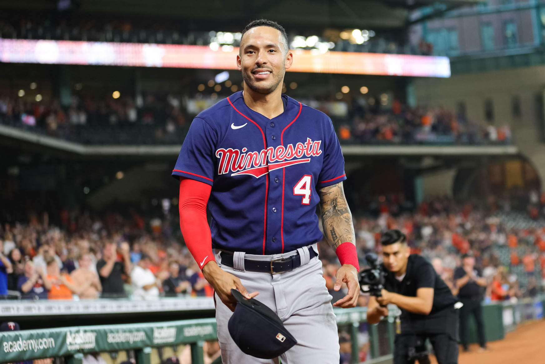 HOUSTON, TEXAS - AUGUST 23: Carlos Correa #4 of the Minnesota Twins gestures to the crowd in his first visit back to Minute Maid Park to face the Houston Astros on August 23, 2022 in Houston, Texas. (Photo by Carmen Mandato/Getty Images)