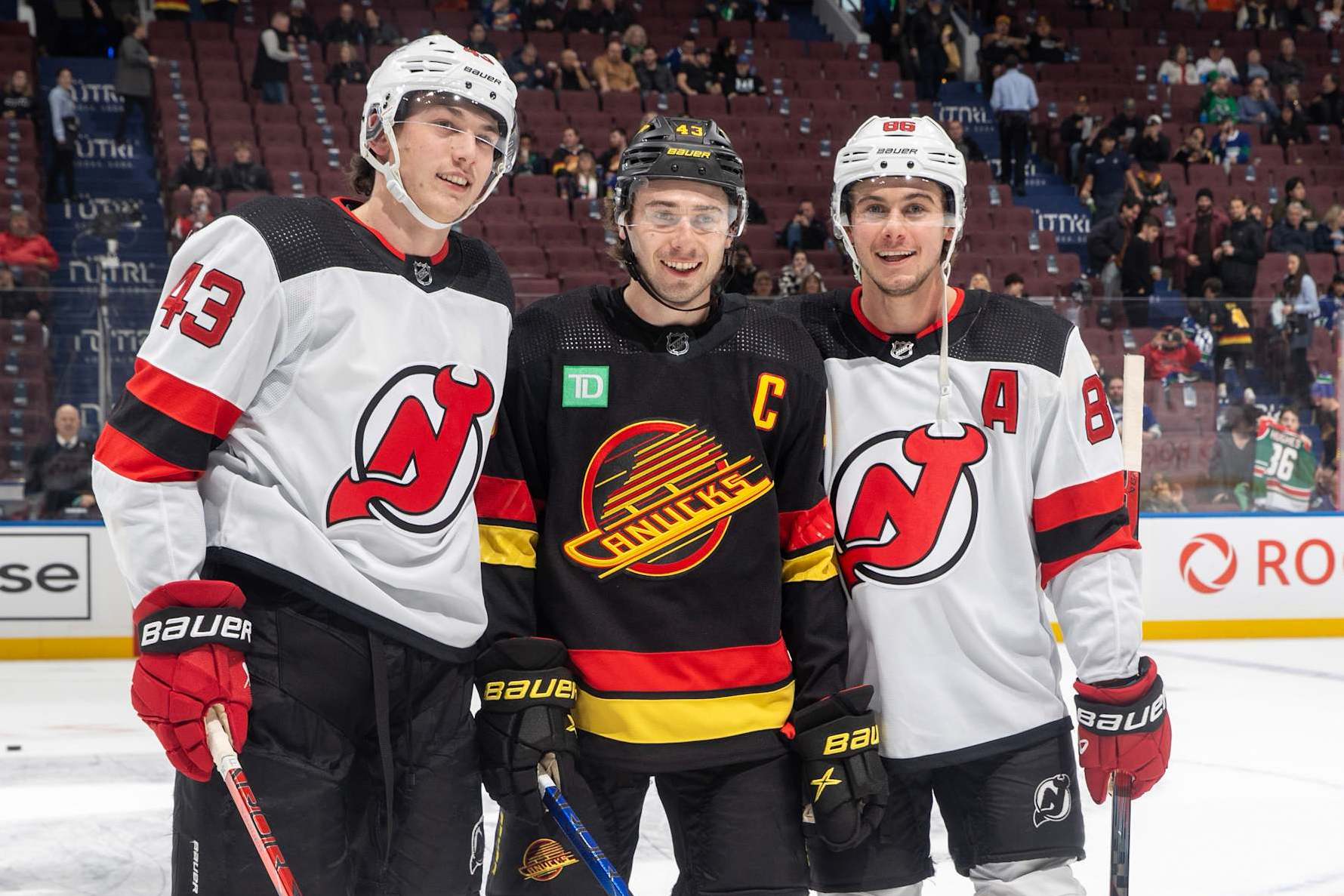 VANCOUVER, CANADA - DECEMBER 05: Quinn Hughes #43 of the Vancouver Canucks and Jack Hughes #86 and Luke Hughes #43 of the New Jersey Devils pose for a photo before their NHL game at Rogers Arena on December 5, 2023 in Vancouver, British Columbia, Canada. (Photo by Jeff Vinnick/NHLI via Getty Images)