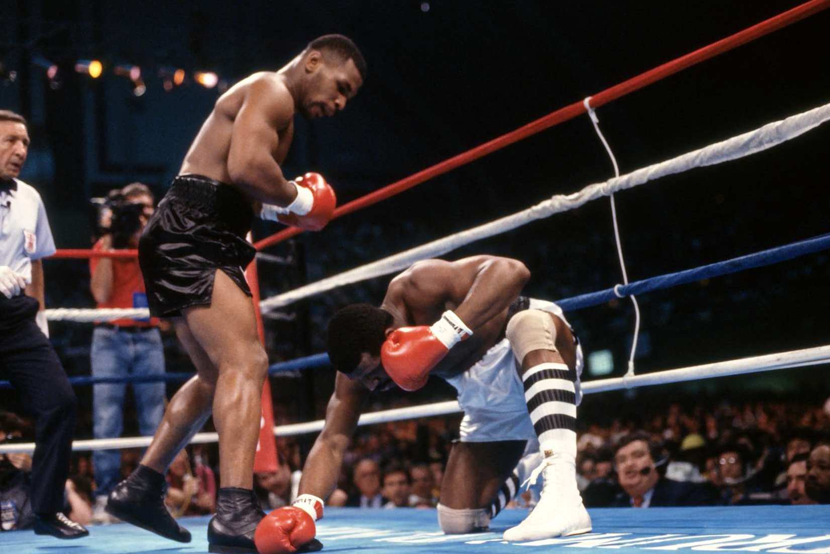 Boxing: WBC/ WBA/ IBF Heavyweight Title: Mike Tyson (L) in action, making round 1 knockdown of Michael Spinks at Boardwalk Convention Hall. View of referee Frank Cappuccino.
Atlantic City, NJ 6/27/1988
CREDIT: Neil Leifer (Photo by Neil Leifer /Sports Illustrated/Getty Images)
(Set Number: T1001 TK1 R1 F20 )