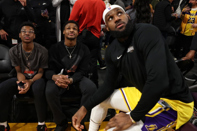 LOS ANGELES, CA - FEBRUARY 7: LeBron James #6 of the Los Angeles Lakers talks with Brice James and Bronny James during the game against the Oklahoma City Thunder on February 7, 2023 at Crypto.Com Arena in Los Angeles, California. NOTE TO USER: User expressly acknowledges and agrees that, by downloading and/or using this Photograph, user is consenting to the terms and conditions of the Getty Images License Agreement. Mandatory Copyright Notice: Copyright 2023 NBAE (Photo by Jim Poorten/NBAE via Getty Images)