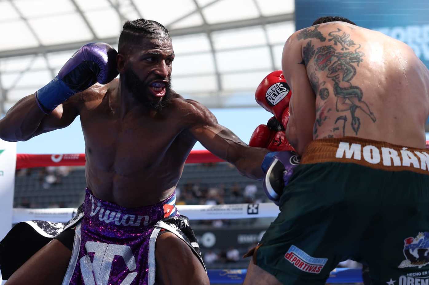 LOS ANGELES, CALIFORNIA - AUGUST 3: Andy Cruz (purple shorts) and Antonio Moran (green shorts) during their IBF International and WBA Continental Latin American Lightweight Titles Contest, at BMO Stadium on August 3, 2024 in Los Angeles, California. (Photo by Mark Robinson/Matchroom Boxing/Getty Images)