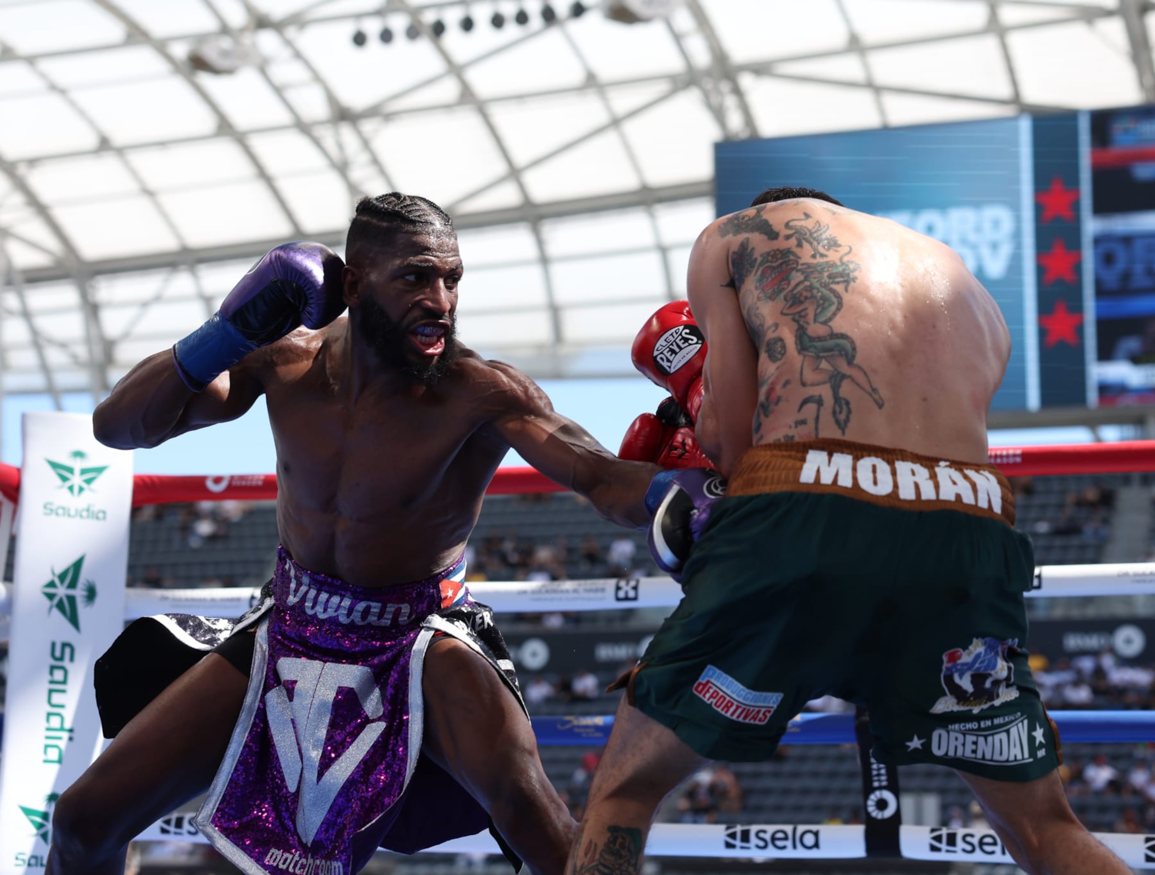 LOS ANGELES, CALIFORNIA - AUGUST 3: Andy Cruz (purple shorts) and Antonio Moran (green shorts) during their IBF International and WBA Continental Latin American Lightweight Titles Contest,  at BMO Stadium on August 3, 2024 in Los Angeles, California.  (Photo by Mark Robinson/Matchroom Boxing/Getty Images)