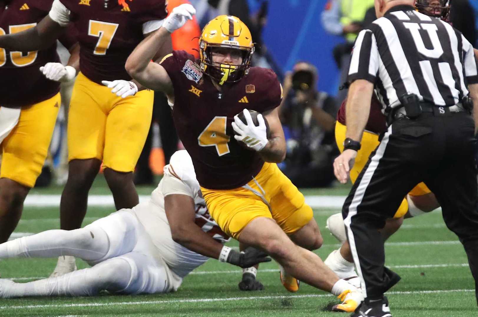 ATLANTA, GEORGIA - JANUARY 1: Runningback Cam Skattebo #4 of the Arizona State Sun Devils rushes for a first down in the second half of the 2025 Peach Bowl College Football Playoff quarterfinals football game featuring the University of Texas Longhorns versus the Arizona State Sun Devils at Mercedes-Benz Stadium on January 1, 2025 in Atlanta, Georgia. (Photo by Bruce Yeung/Getty Images)