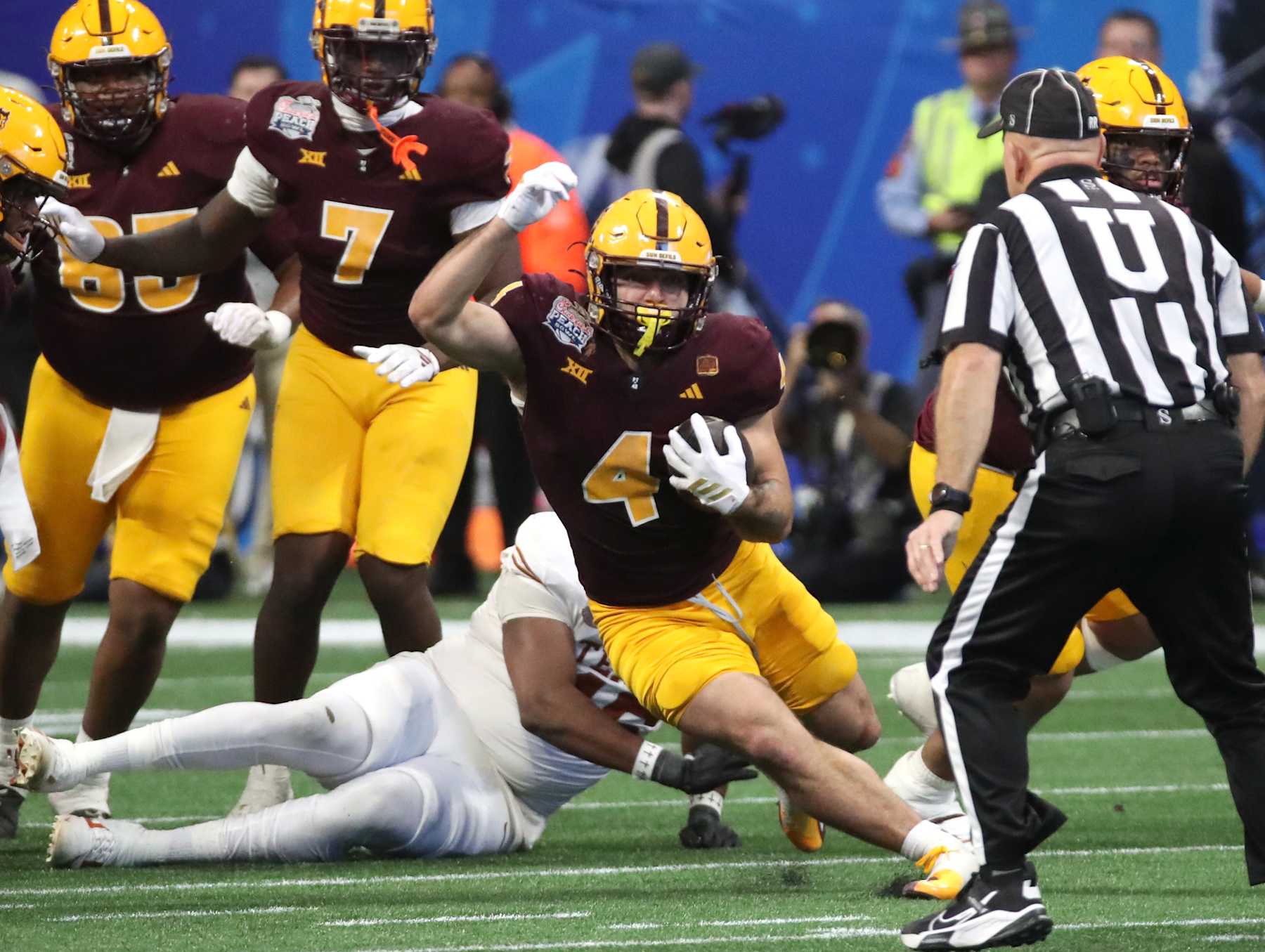 ATLANTA, GEORGIA - JANUARY 1:  Runningback Cam Skattebo #4 of the Arizona State Sun Devils rushes for a first down in the second half of the 2025 Peach Bowl College Football Playoff quarterfinals football game featuring the University of Texas Longhorns versus the Arizona State Sun Devils at Mercedes-Benz Stadium on January 1, 2025 in Atlanta, Georgia. (Photo by Bruce Yeung/Getty Images)