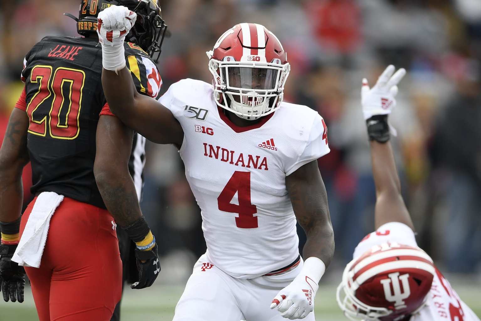 Indiana linebacker Cam Jones (4) reacts as his team stopped Maryland on a fourth down play during the first half of an NCAA college football game, Saturday, Oct. 19, 2019, in College Park, Md. Maryland running back Javon Leake (20) looks on. (AP Photo/Nick Wass)
