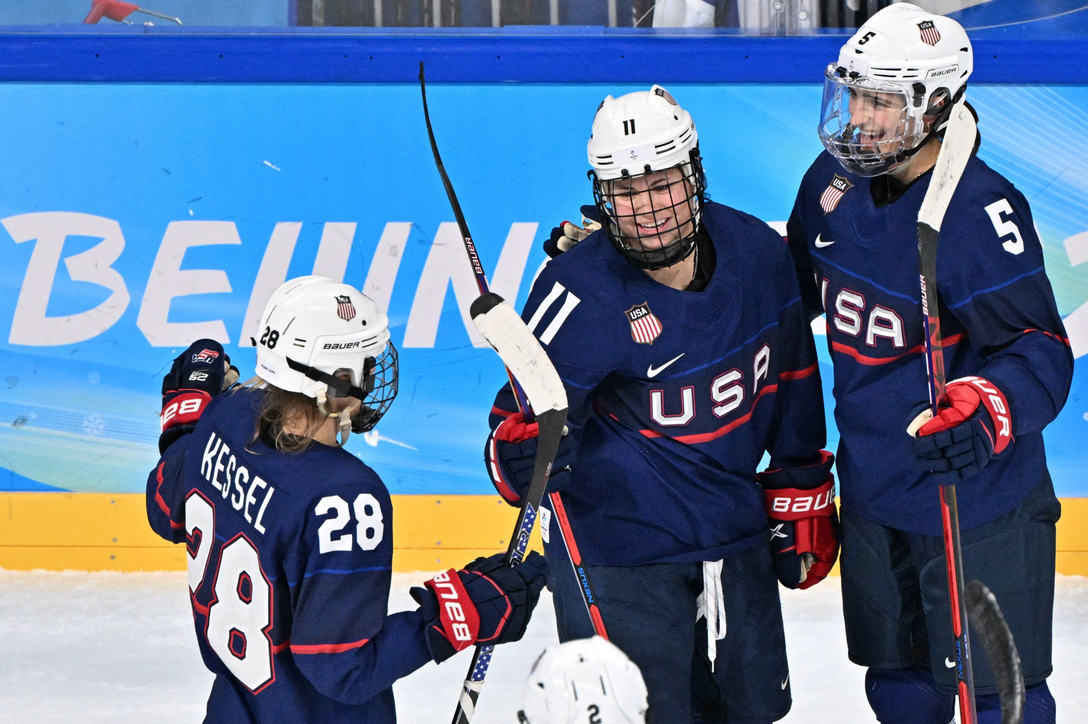 USA's Abby Roque (C) celebrates with teammates after scoring her side's 4th goal during the women's play-offs semifinal match of the Beijing 2022 Winter Olympic Games ice hockey competition between USA and Finland, at the Wukesong Sports Centre in Beijing on February 14, 2022. (Photo by ANTHONY WALLACE / AFP) (Photo by ANTHONY WALLACE/AFP via Getty Images)