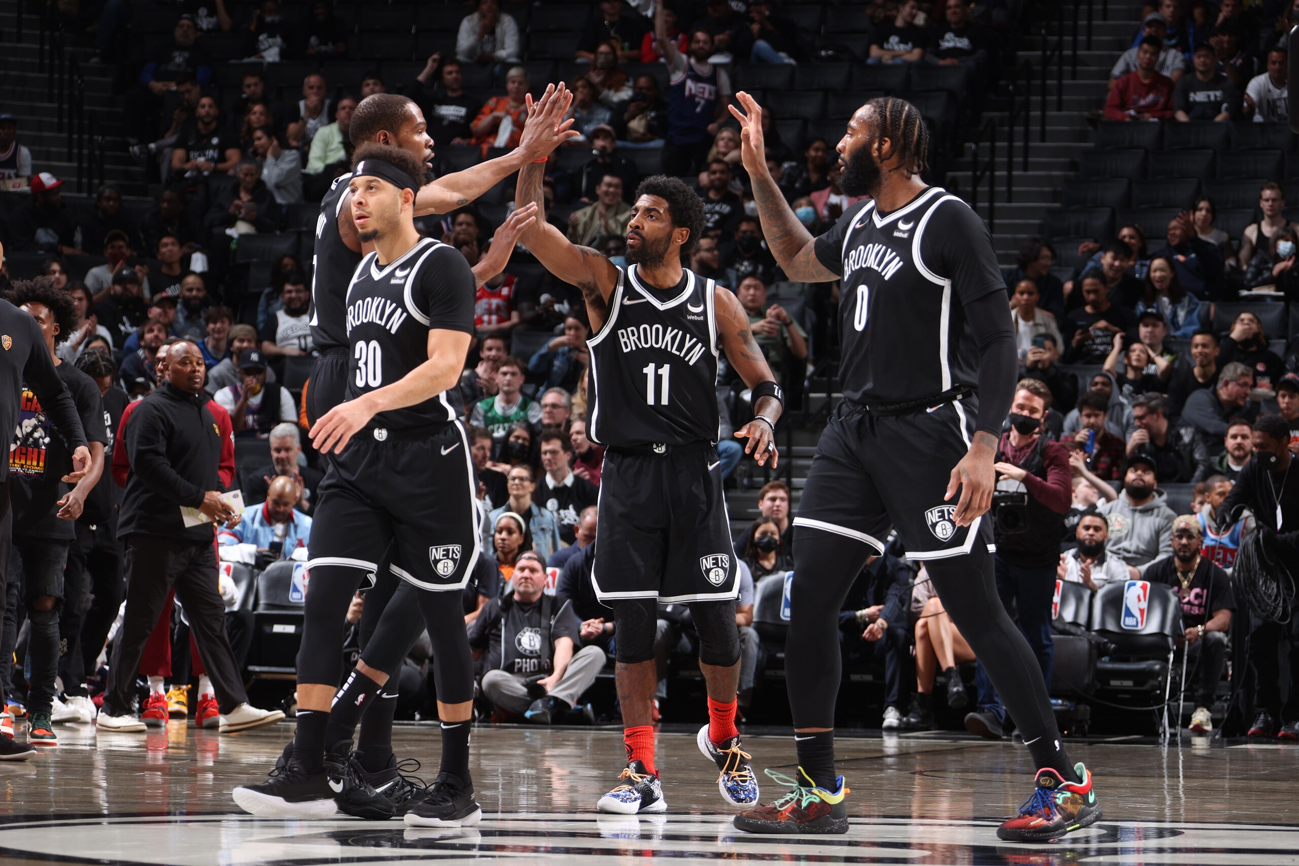 BROOKLYN, NY - APRIL 12: Kyrie Irving #11 hi-fives Kevin Durant #7 and Andre Drummond #0 of the Brooklyn Nets during the game against the Cleveland Cavaliers during the 2022 Play-In Tournament on April 12, 2022 at Barclays Center in Brooklyn, New York. NOTE TO USER: User expressly acknowledges and agrees that, by downloading and or using this Photograph, user is consenting to the terms and conditions of the Getty Images License Agreement. Mandatory Copyright Notice: Copyright 2022 NBAE (Photo by Nathaniel S. Butler/NBAE via Getty Images)