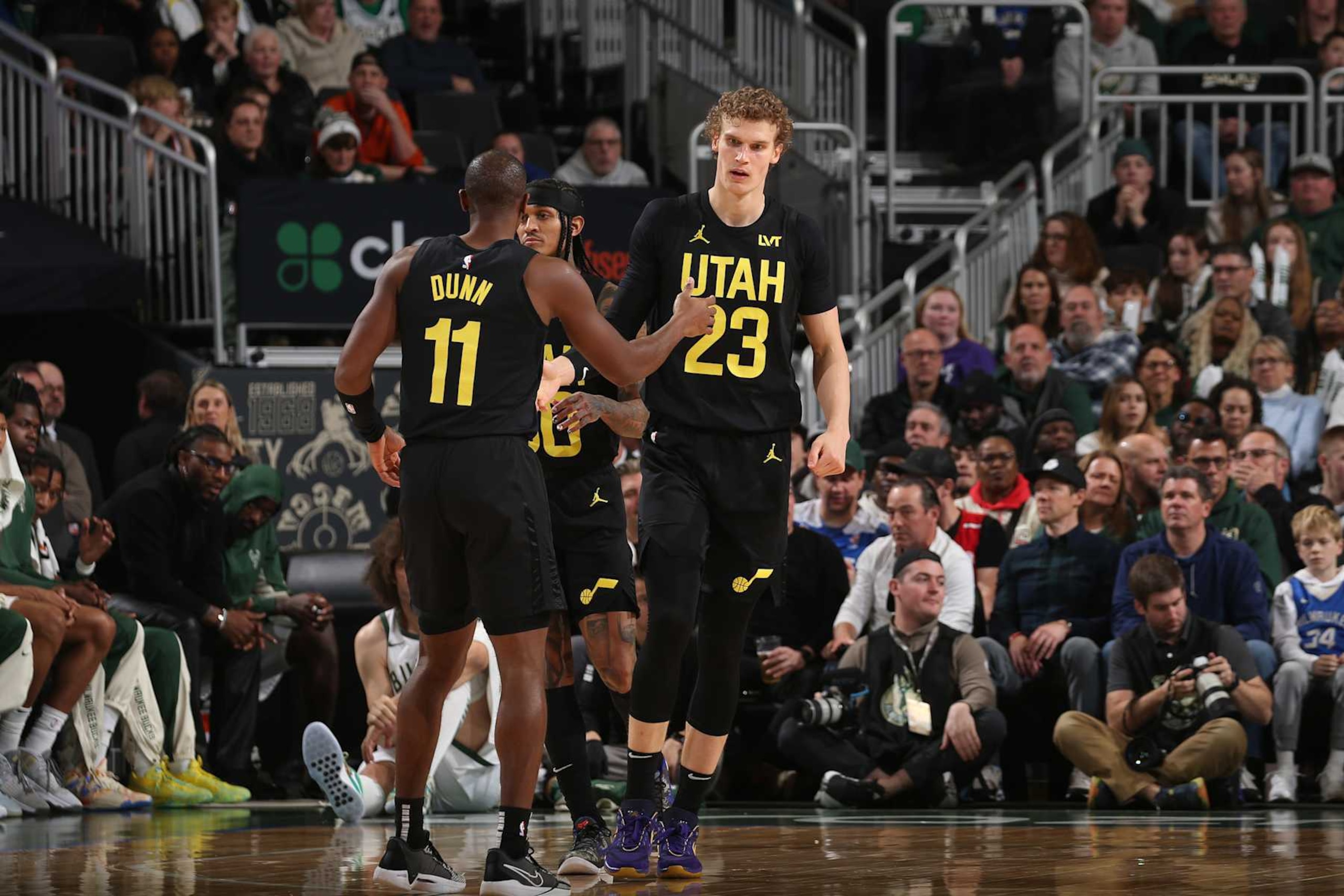 MILWAUKEE, WI - JANUARY 8:  Lauri Markkanen #23 and Kris Dunn #11 of the Utah Jazz react during the game against the Milwaukee Bucks on January 8, 2024 at the Fiserv Forum Center in Milwaukee, Wisconsin. NOTE TO USER: User expressly acknowledges and agrees that, by downloading and or using this Photograph, user is consenting to the terms and conditions of the Getty Images License Agreement. Mandatory Copyright Notice: Copyright 2024 NBAE (Photo by Gary Dineen/NBAE via Getty Images).