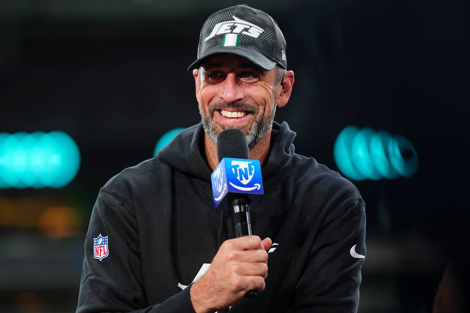 EAST RUTHERFORD, NJ - OCTOBER 31: Aaron Rodgers #8 of the New York Jets visits on set of the TNF on Prime postgame show after an NFL football game between the Houston Texans and the New York Jets at MetLife Stadium on October 31, 2024 in East Rutherford, New Jersey. (Photo by Cooper Neill/Getty Images)