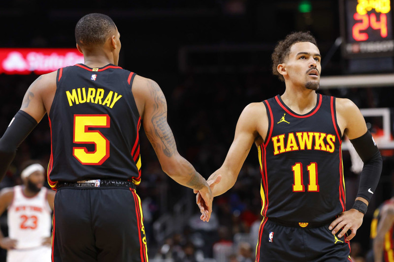 ATLANTA, GEORGIA - NOVEMBER 15: Trae Young #11 reacts with Dejounte Murray #5 of the Atlanta Hawks during the first half against the New York Knicks at State Farm Arena on November 15, 2023 in Atlanta, Georgia. NOTE TO USER: User expressly acknowledges and agrees that, by downloading and or using this photograph, User is consenting to the terms and conditions of the Getty Images License Agreement. (Photo by Todd Kirkland/Getty Images)