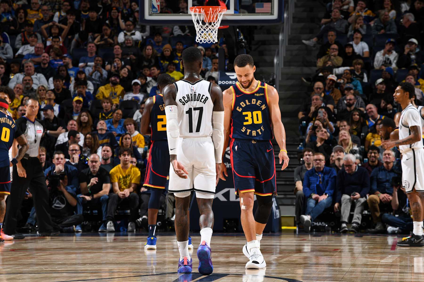 SAN FRANCISCO, CA - NOVEMBER 25: Dennis Schroder #17 of the Brooklyn Nets and Stephen Curry #30 of the Golden State Warriors look on during the game on November 25, 2024 at Chase Center in San Francisco, California. NOTE TO USER: User expressly acknowledges and agrees that, by downloading and or using this photograph, user is consenting to the terms and conditions of Getty Images License Agreement. Mandatory Copyright Notice: Copyright 2024 NBAE (Photo by Noah Graham/NBAE via Getty Images)