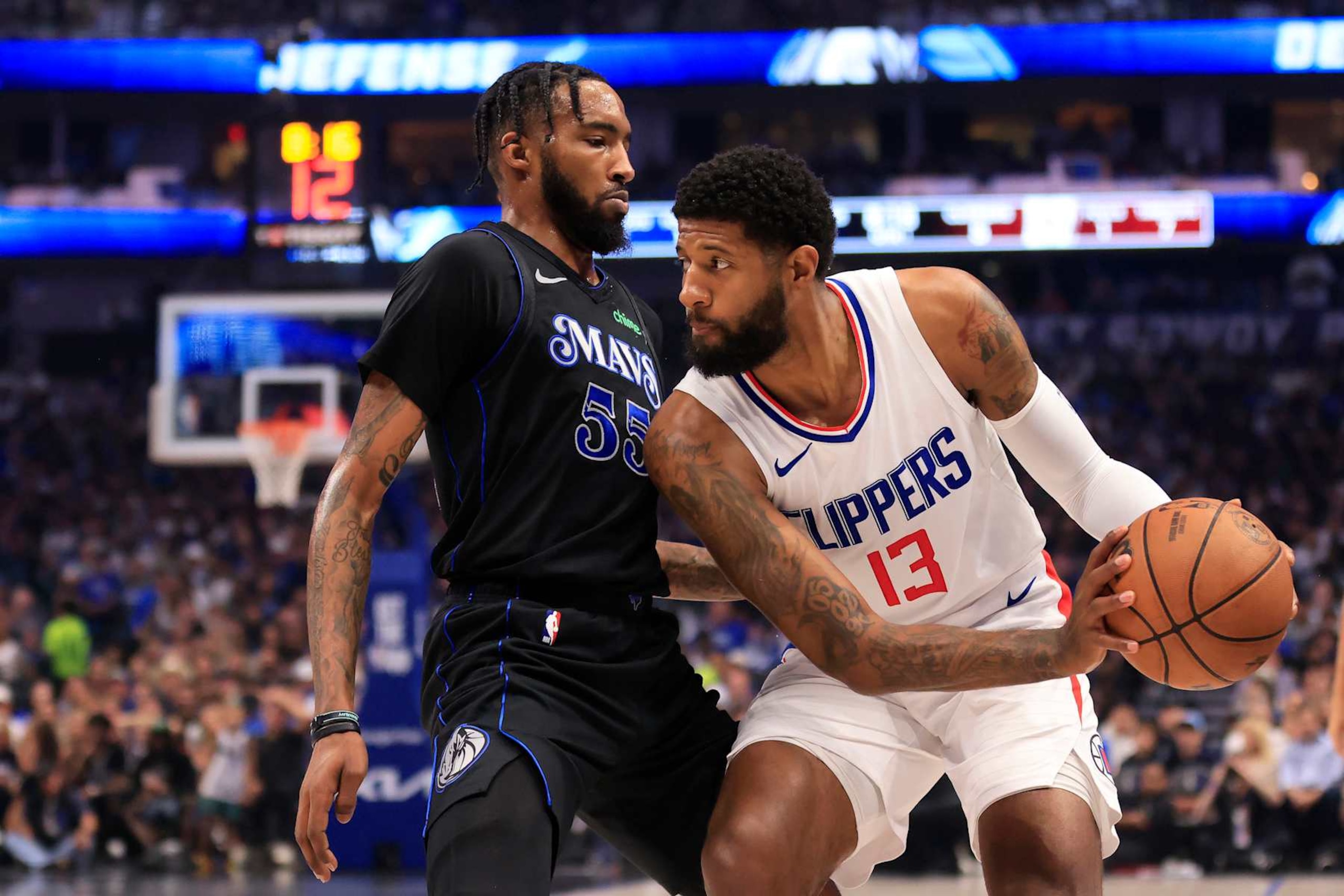 DALLAS, TEXAS - MAY 03: Paul George #13 of the LA Clippers drives the ball against Derrick Jones Jr. #55 of the Dallas Mavericks during the first quarter in Game Six of the Western Conference First Round Playoffs at American Airlines Center on May 03, 2024 in Dallas, Texas.  (Photo by Ron Jenkins/Getty Images)