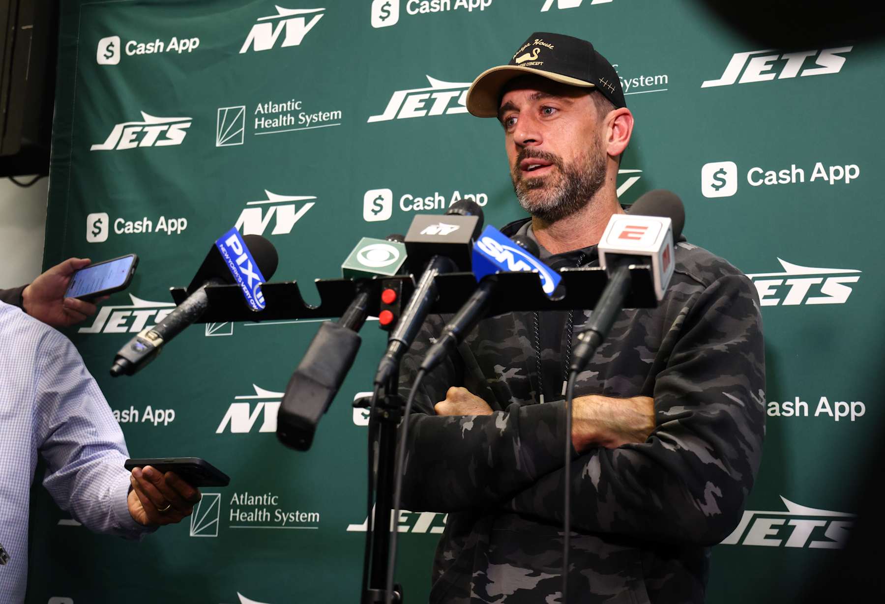 EAST RUTHERFORD, NEW JERSEY - OCTOBER 16: Aaron Rodgers #8 of the New York Jets speaks to members of the media at the Atlantic Health Jets Training Center on October 16, 2024 in Florham Park, New Jersey. (Photo by Ed Mulholland/Getty Images)