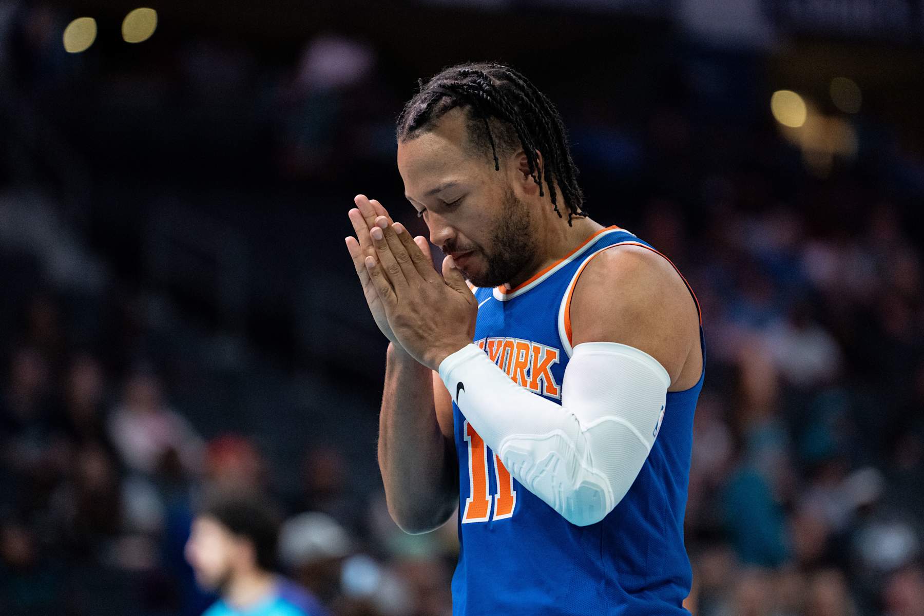 CHARLOTTE, NORTH CAROLINA - OCTOBER 06: Jalen Brunson #11 of the New York Knicks takes a moment before a preseason game against the Charlotte Hornets at Spectrum Center on October 06, 2024 in Charlotte, North Carolina. NOTE TO USER: User expressly acknowledges and agrees that, by downloading and or using this photograph, User is consenting to the terms and conditions of the Getty Images License Agreement. (Photo by Jacob Kupferman/Getty Images)