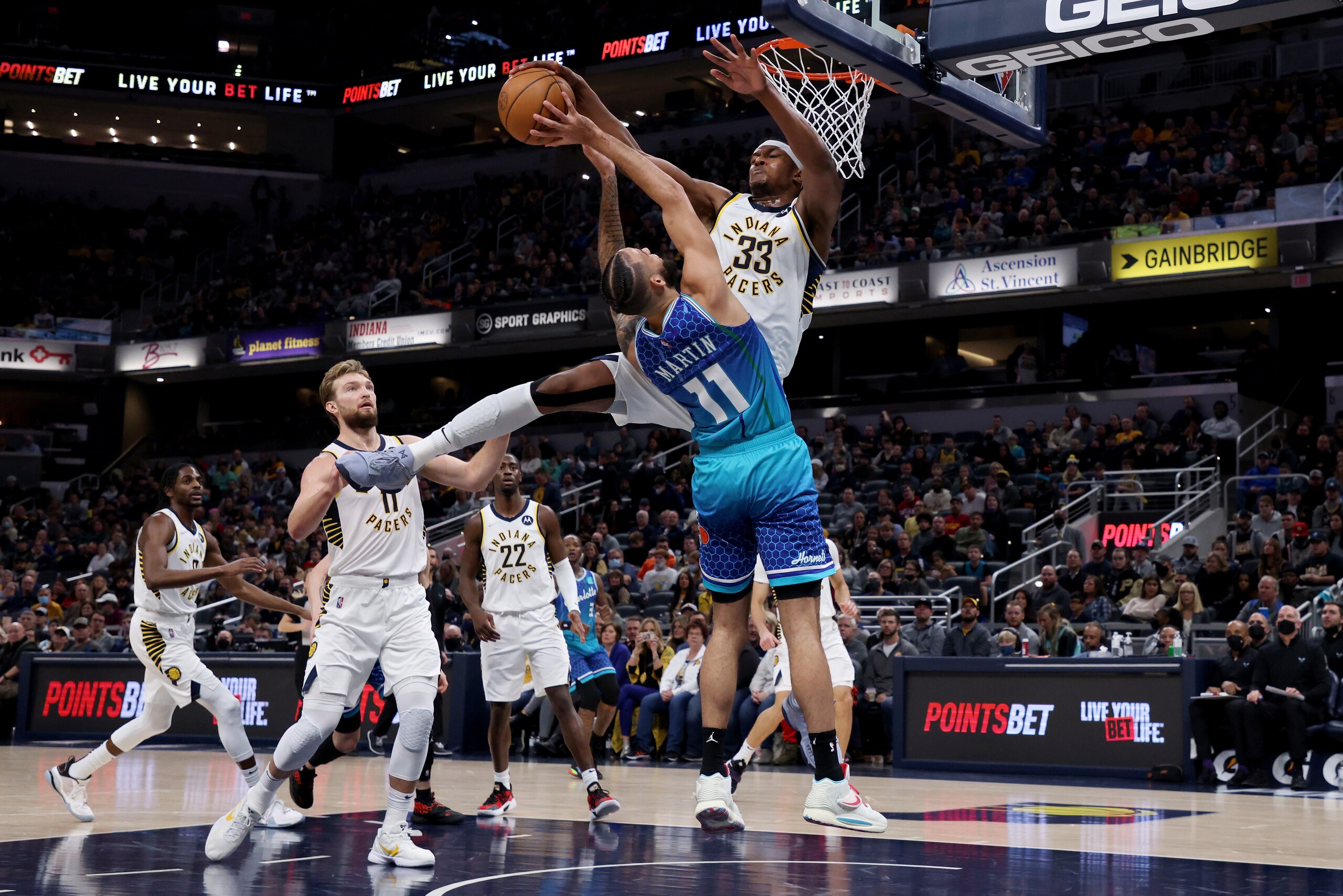 INDIANAPOLIS, INDIANA - DECEMBER 29: Myles Turner #33 of the Indiana Pacers blocks a shot attempt by Cody Martin #11 of the Charlotte Hornets in the second quarter at Gainbridge Fieldhouse on December 29, 2021 in Indianapolis, Indiana. NOTE TO USER: User expressly acknowledges and agrees that, by downloading and or using this Photograph, user is consenting to the terms and conditions of the Getty Images License Agreement. (Photo by Dylan Buell/Getty Images) INDIANAPOLIS, INDIANA - DECEMBER 29: Myles Turner #33 of the Indiana Pacers blocks a shot attempt by Cody Martin #11 of the Charlotte Hornets in the second quarter at Gainbridge Fieldhouse on December 29, 2021 in Indianapolis, Indiana. NOTE TO USER: User expressly acknowledges and agrees that, by downloading and or using this Photograph, user is consenting to the terms and conditions of the Getty Images License Agreement. (Photo by Dylan Buell/Getty Images)