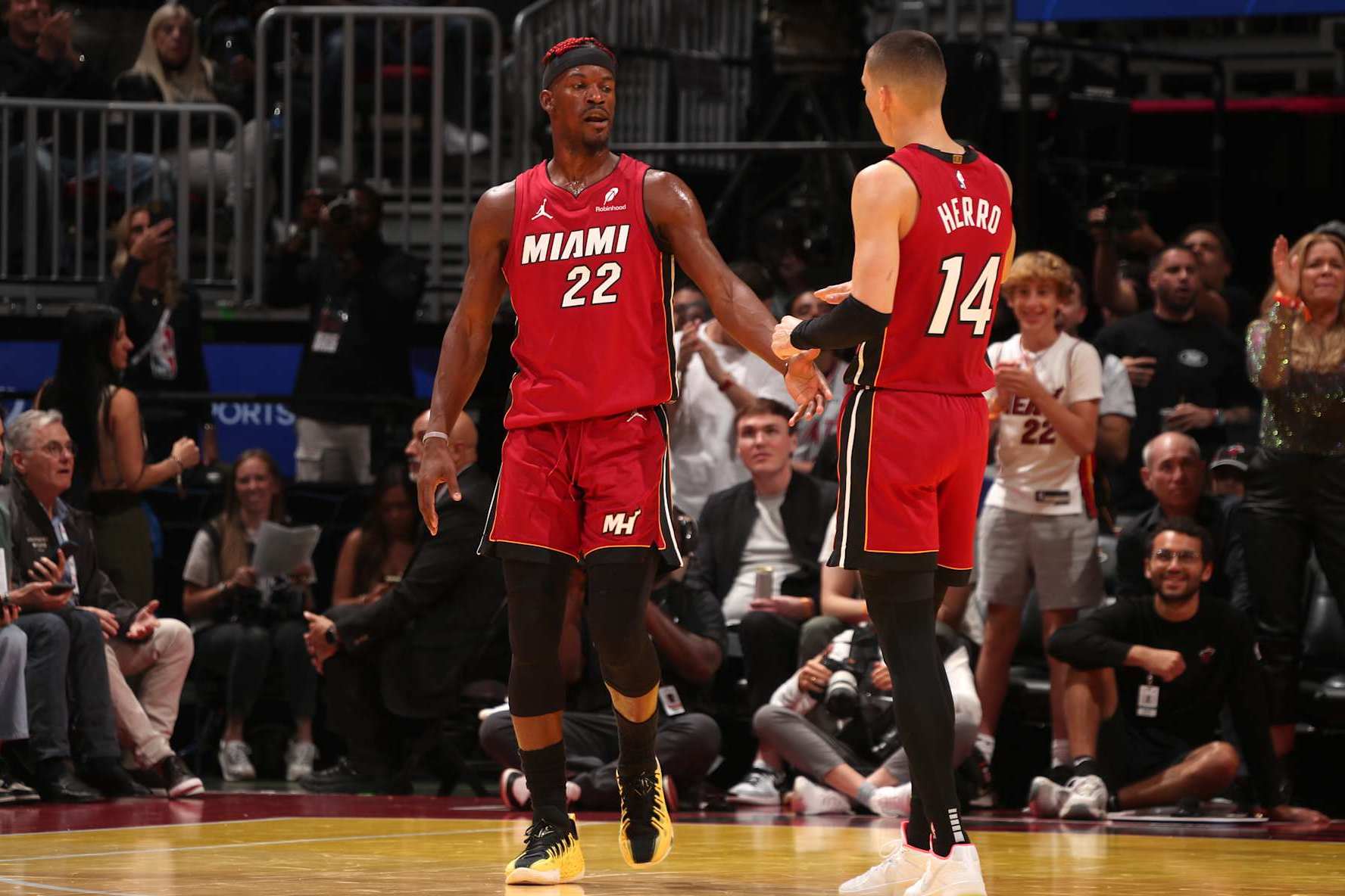 MIAMI, FL - NOVEMBER 26: Jimmy Butler #22 and Tyler Herro #14 of the Miami Heat high five during the game against the Milwaukee Bucks during the Emirates NBA Cup game on November 26, 2024 at Kaseya Center in Miami, Florida. NOTE TO USER: User expressly acknowledges and agrees that, by downloading and or using this Photograph, user is consenting to the terms and conditions of the Getty Images License Agreement. Mandatory Copyright Notice: Copyright 2024 NBAE (Photo by Issac Baldizon/NBAE via Getty Images)