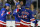 NEW YORK, NEW YORK - JANUARY 10:  Adam Fox #23 of the New York Rangers is congratulated by teammates after scoring during the game against the Minnesota Wild at Madison Square Garden on January 10, 2023 in New York City. (Photo by Jamie Squire/Getty Images)