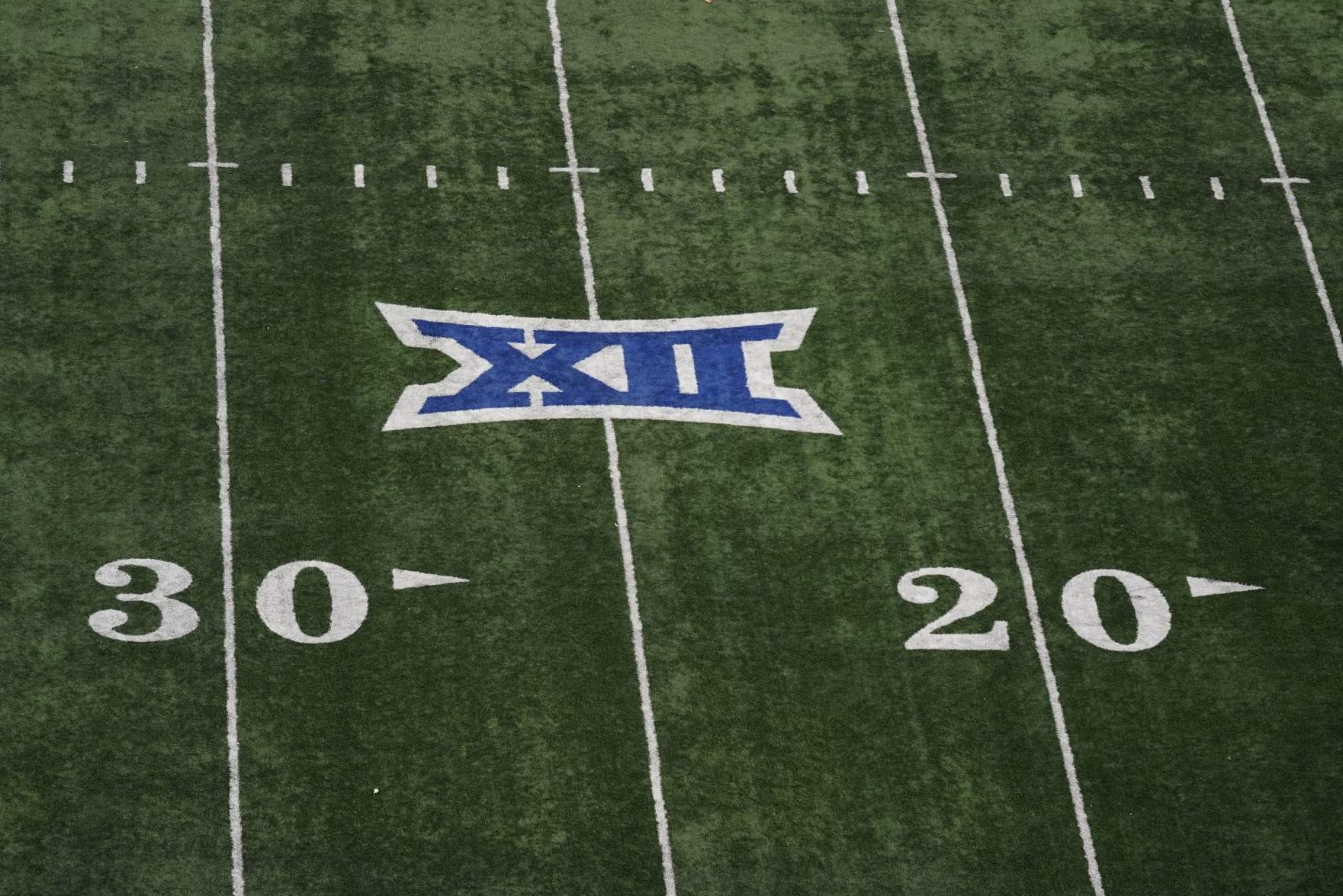 The Big 12 Conference logo is seen on the field at Memorial Stadium during the second half of an NCAA college football game between Kansas and Oklahoma State Saturday, Nov. 5, 2022, in Lawrence, Kan. (AP Photo/Charlie Riedel)