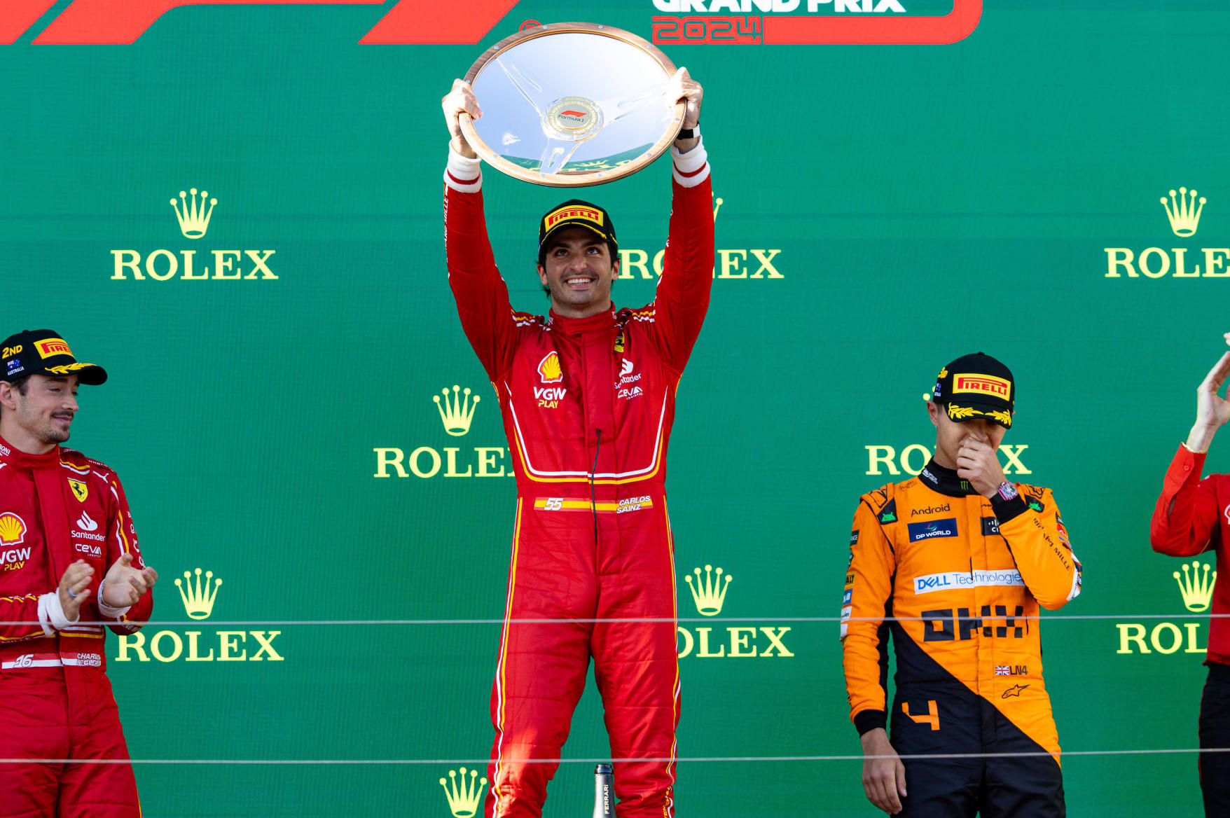 MELBOURNE, AUSTRALIA - MARCH 24: Carlos Sainz of Spain and Scuderia Ferrari, Lando Norris of Great Britain and McLaren F1 and Charles Leclerc of Monaco and Scuderia Ferrari on the podium after the F1 Grand Prix of Australia at Albert Park Circuit on March 24, 2024 in Melbourne, Australia. (Photo by Kym Illman/Getty Images)