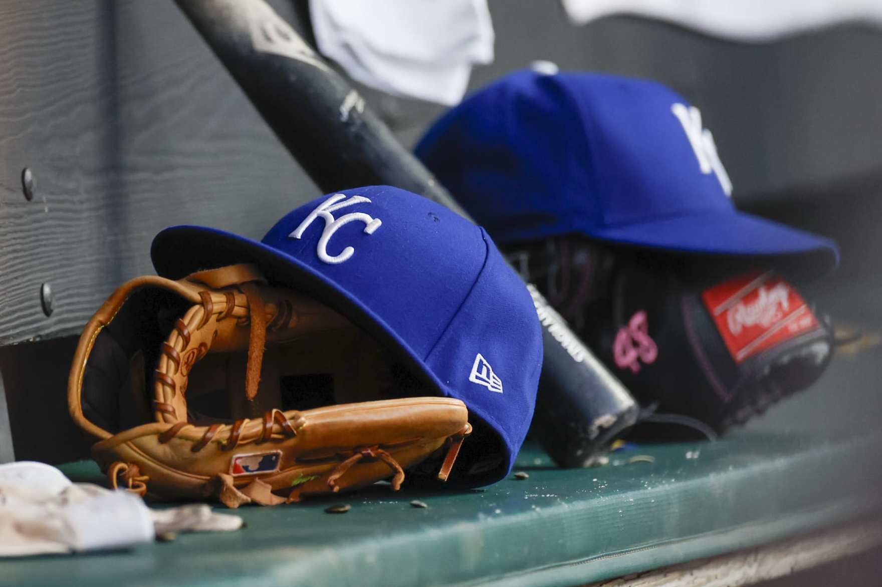CLEVELAND, OH - JULY 24: A Kansas City Royals hat and a glove sit in the dugout during the sixth inning of a game against the Cleveland Guardians at Progressive Field on July 24, 2023 in Cleveland, Ohio. (Photo by Ron Schwane/Getty Images)