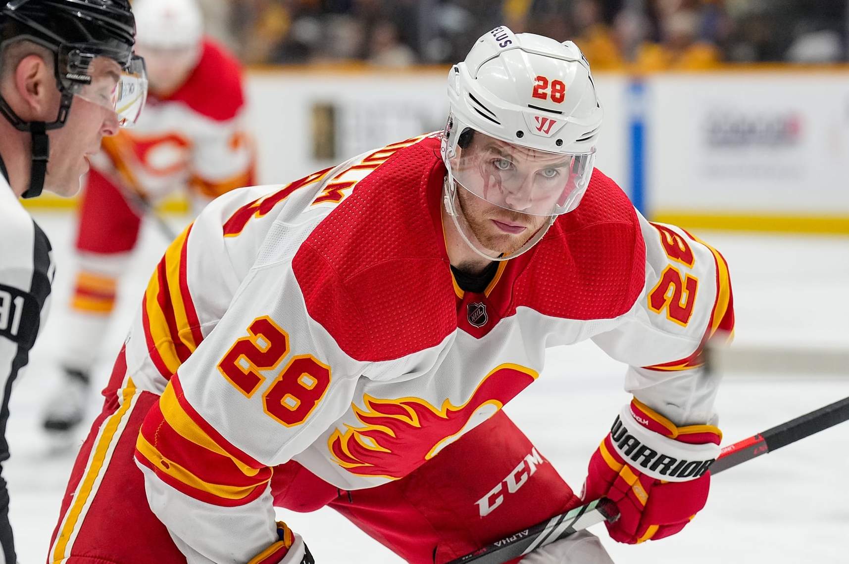 NASHVILLE, TENNESSEE - JANUARY 4: Elias Lindholm #28 of the Calgary Flames faces off against the Nashville Predators during an NHL game at Bridgestone Arena on January 4, 2024 in Nashville, Tennessee. (Photo by John Russell/NHLI via Getty Images)