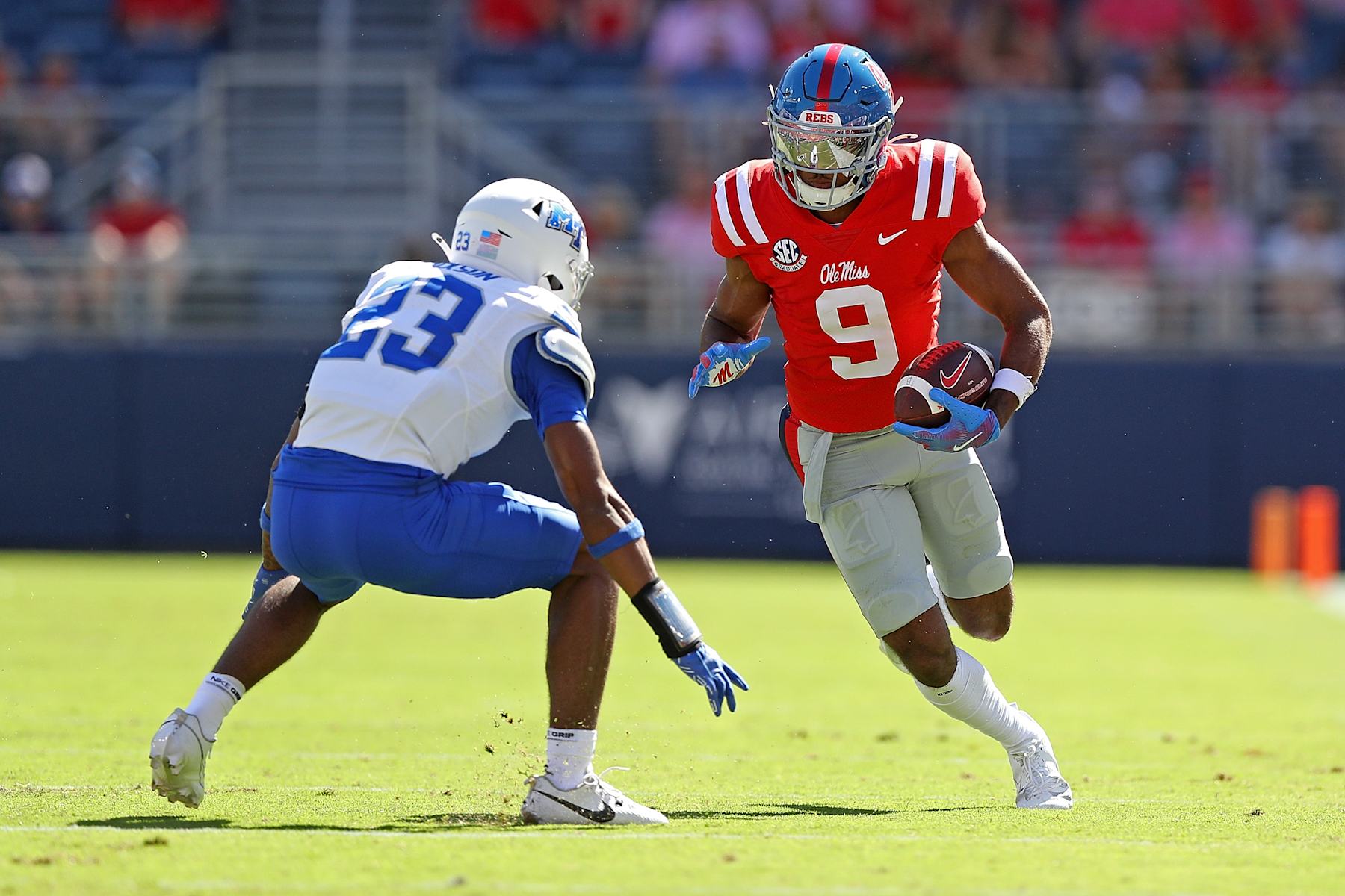 OXFORD, MISSISSIPPI - SEPTEMBER 07: Tre Harris #9 of the Mississippi Rebels carries the ball against Jalen Jackson #23 of the Middle Tennessee Blue Raiders during the game at Vaught-Hemingway Stadium on September 07, 2024 in Oxford, Mississippi. (Photo by Justin Ford/Getty Images)
