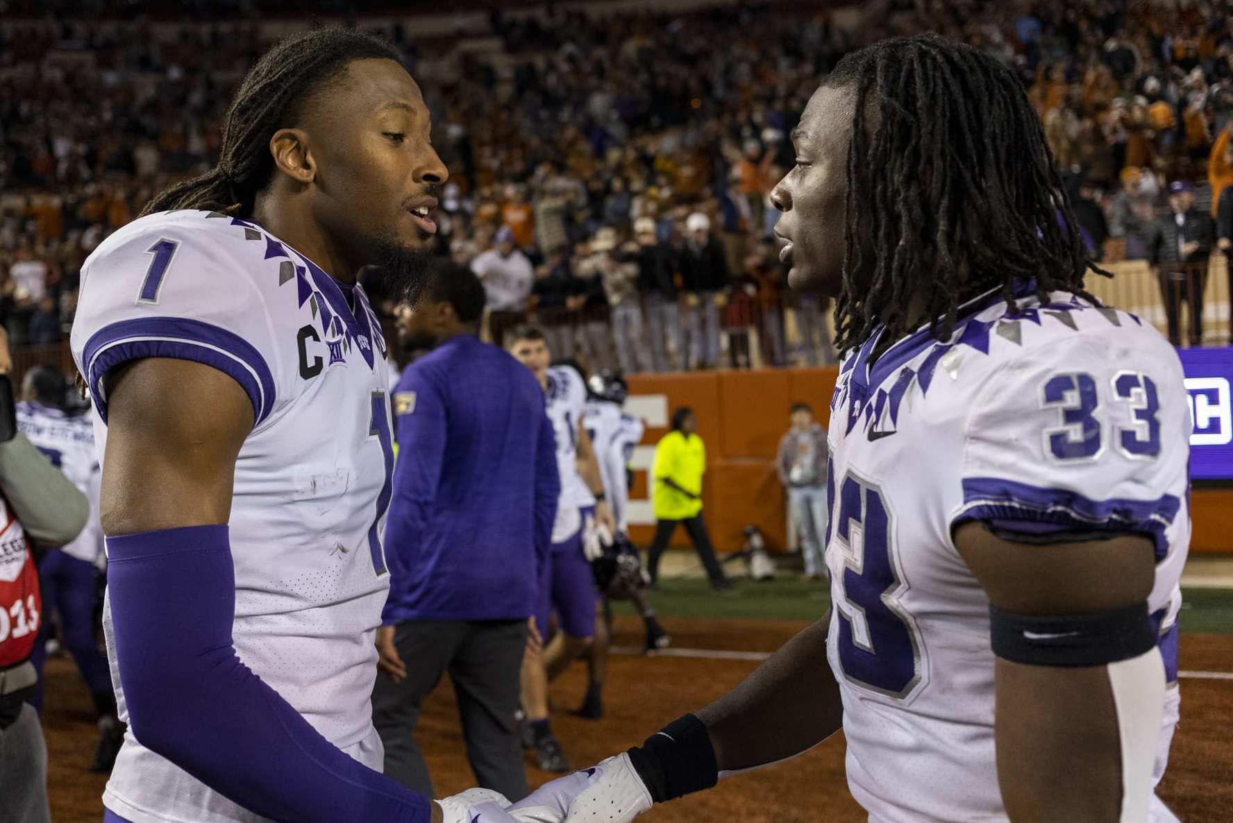 TCU wide receiver Quentin Johnston (1) and running back Kendre Miller (33) celebrate the team's win over Texas in an NCAA college football game Saturday, Nov. 12, 2022, in Austin, Texas. (AP Photo/Stephen Spillman)