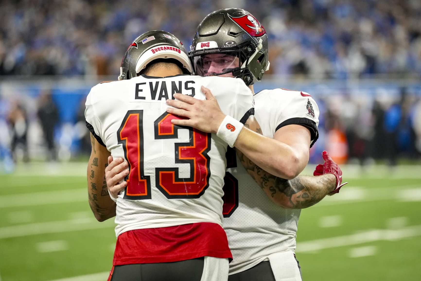 DETROIT, MICHIGAN - JANUARY 21: Baker Mayfield #6 of the Tampa Bay Buccaneers embraces Mike Evans #13 of the Tampa Bay Buccaneers after throwing an interception against the Detroit Lions during the fourth quarter of the NFC Divisional Playoff game at Ford Field on January 21, 2024 in Detroit, Michigan. (Photo by Nic Antaya/Getty Images)