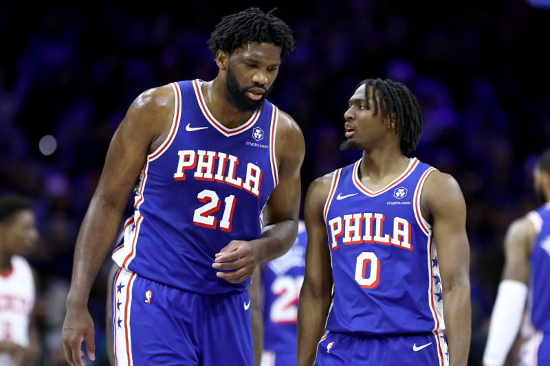 PHILADELPHIA, PENNSYLVANIA - JANUARY 15: Joel Embiid #21 and Tyrese Maxey #0 of the Philadelphia 76ers speak during the first quarter against the Houston Rockets at the Wells Fargo Center on January 15, 2024 in Philadelphia, Pennsylvania. NOTE TO USER: User expressly acknowledges and agrees that, by downloading and or using this photograph, User is consenting to the terms and conditions of the Getty Images License Agreement. (Photo by Tim Nwachukwu/Getty Images)