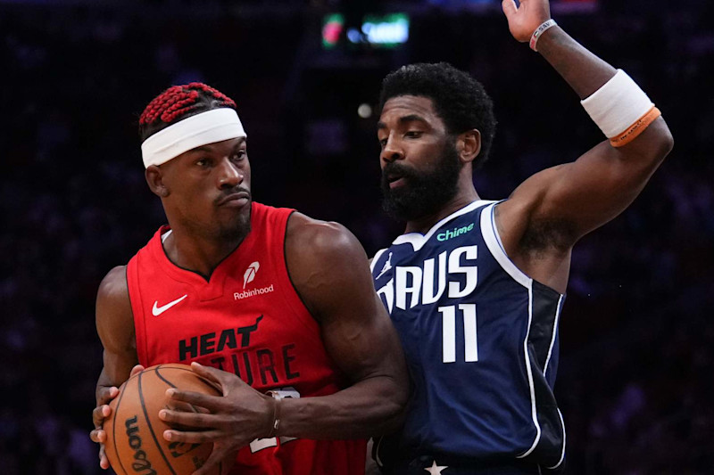 MIAMI, FLORIDA - NOVEMBER 24: Jimmy Butler #22 of the Miami Heat dribbles the ball against Kyrie Irving #11 of the Dallas Mavericks during the fourth quarter at Kaseya Center on November 24, 2024 in Miami, Florida. NOTE TO USER: User expressly acknowledges and agrees that, by downloading and or using this photograph, User is consenting to the terms and conditions of the Getty Images License Agreement. (Photo by Rich Storry/Getty Images)