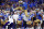 PASADENA, CALIFORNIA - SEPTEMBER 30:  Dorian Thompson-Robinson #1 of the UCLA Bruins jumps over Kamren Fabiculanan #13 of the Washington Huskies in the second quarter at Rose Bowl Stadium on September 30, 2022 in Pasadena, California. (Photo by Ronald Martinez/Getty Images)