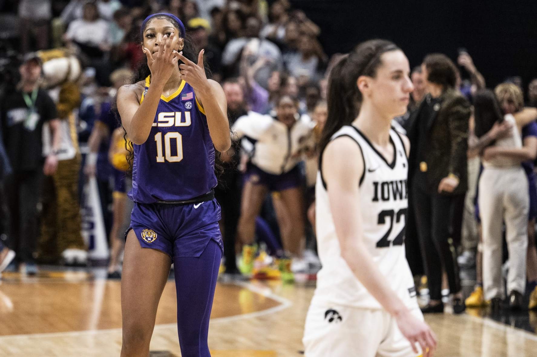 DALLAS, TEXAS - APRIL 02: Angel Reese #10 of the LSU Lady Tigers reacts in front of Caitlin Clark #22 of the Iowa Hawkeyes towards the end of the 2023 NCAA Women's Basketball Tournament championship game at American Airlines Center on April 02, 2023 in Dallas, Texas. (Photo by Ben Solomon/NCAA Photos via Getty Images)