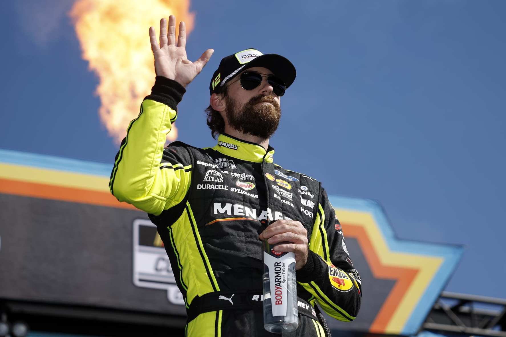 AVONDALE, ARIZONA - NOVEMBER 05: Ryan Blaney, driver of the #12 Menards/Dutch Boy Ford, waves to fans onstage during driver intros prior to the NASCAR Cup Series Championship at Phoenix Raceway on November 05, 2023 in Avondale, Arizona. (Photo by James Gilbert/Getty Images)