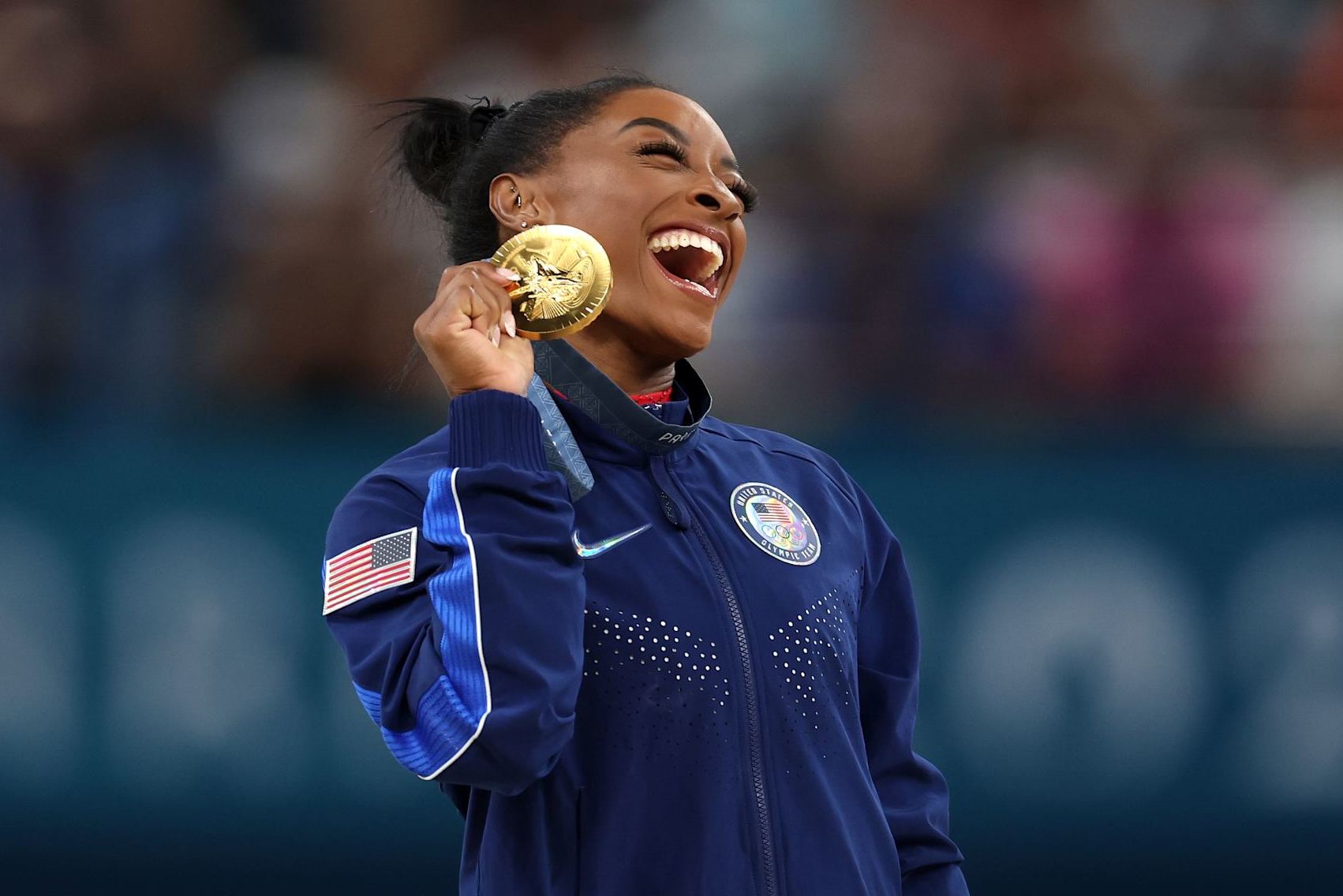 PARIS, FRANCE - AUGUST 03: Gold medalist Simone Biles of Team United States celebrates on the podium during the medal ceremony for the Artistic Gymnastics Women's Vault Final on day eight of the Olympic Games Paris 2024 at Bercy Arena on August 03, 2024 in Paris, France. (Photo by Julian Finney/Getty Images)