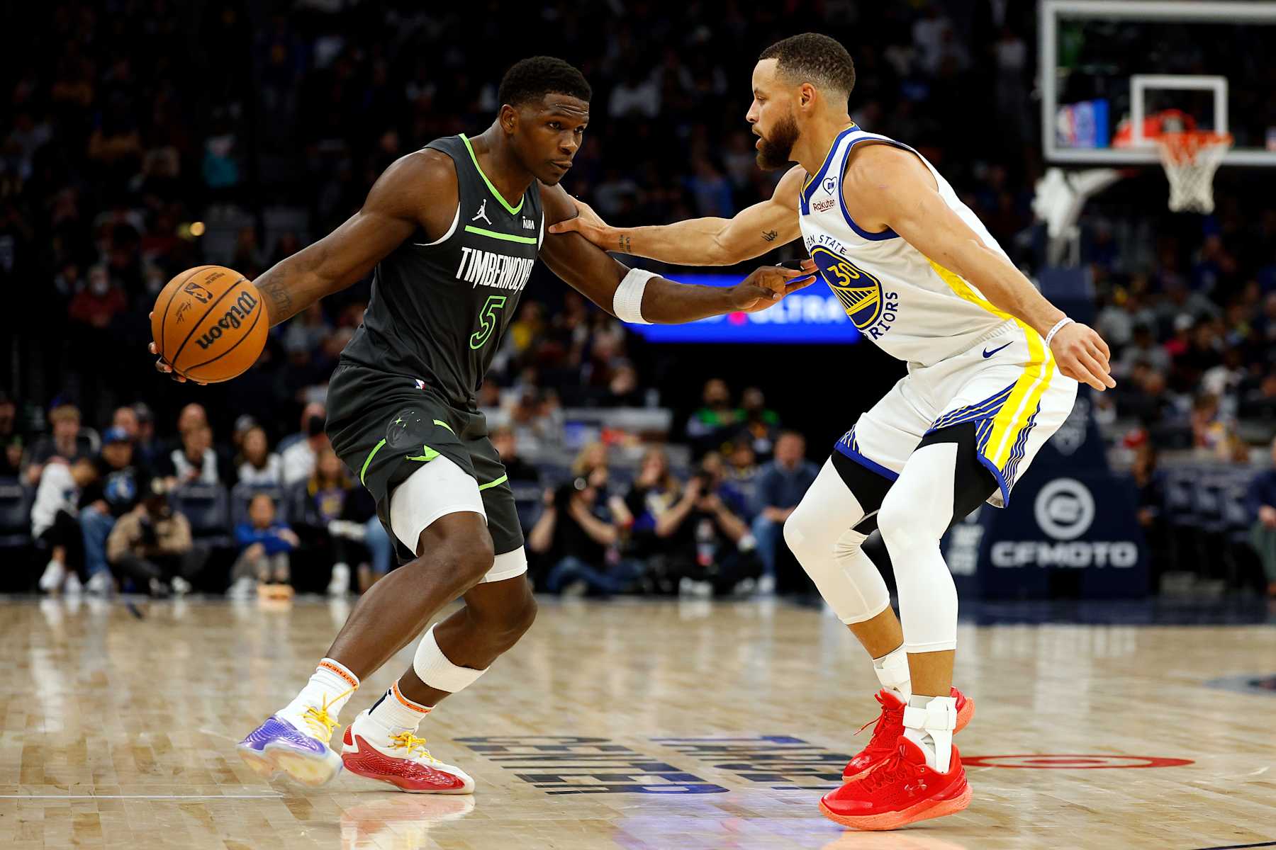 MINNEAPOLIS, MINNESOTA - MARCH 24: Anthony Edwards #5 of the Minnesota Timberwolves dribbles the ball against Stephen Curry #30 of the Golden State Warriors in the third quarter at Target Center on March 24, 2024 in Minneapolis, Minnesota. The Timberwolves defeated the Warriors 114-110. NOTE TO USER: User expressly acknowledges and agrees that, by downloading and or using this photograph, User is consenting to the terms and conditions of the Getty Images License Agreement. (Photo by David Berding/Getty Images)