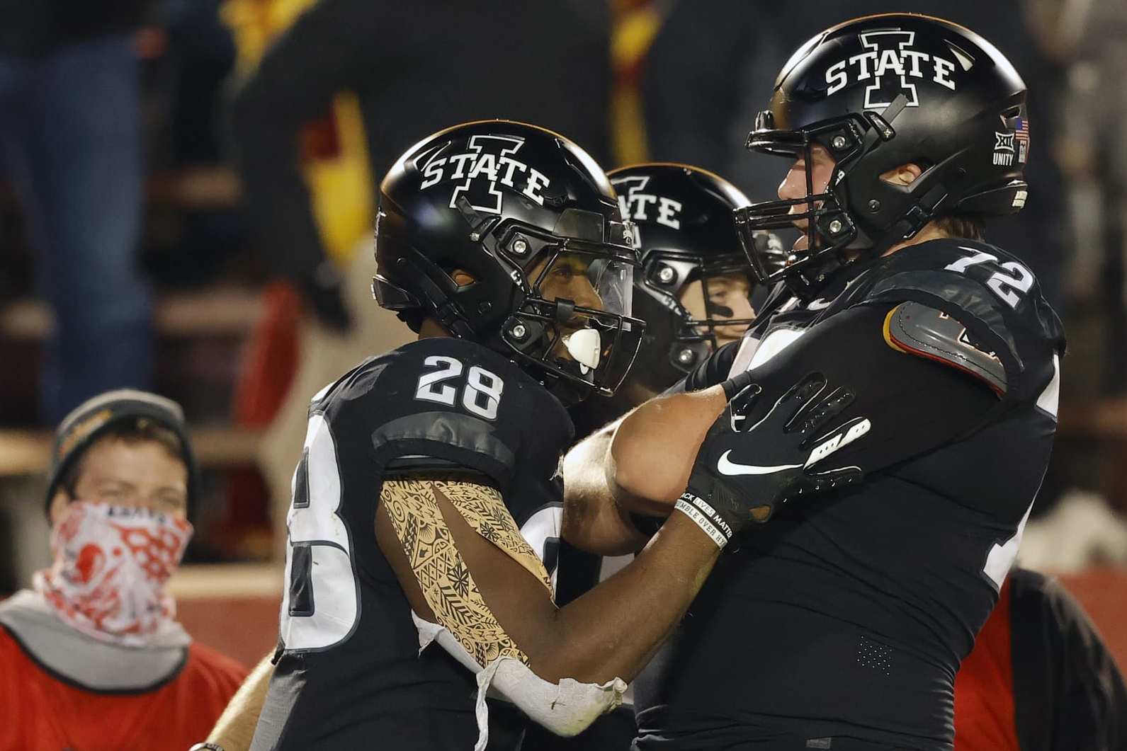 Iowa State running back Breece Hall, left, celebrates his touchdown with offensive lineman Jake Remsburg, right, during the second half of an NCAA college football game against West Virginia on Saturday, Dec. 5, 2020, in Ames, Iowa. (AP Photo/Matthew Putney)