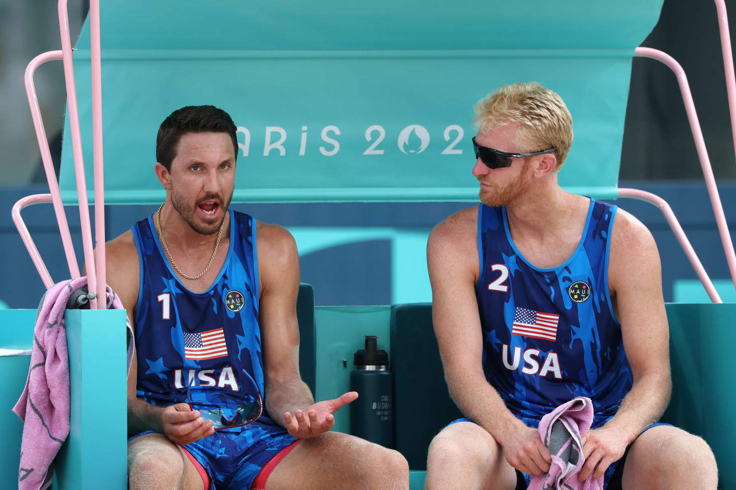 PARIS, FRANCE - AUGUST 02: Miles Evans and Chase Budinger of Team United States react on the bench after losing a Men's Preliminary Phase match to Team Spain on day seven of the Olympic Games Paris 2024 at Eiffel Tower Stadium on August 02, 2024 in Paris, France. (Photo by Elsa/Getty Images)