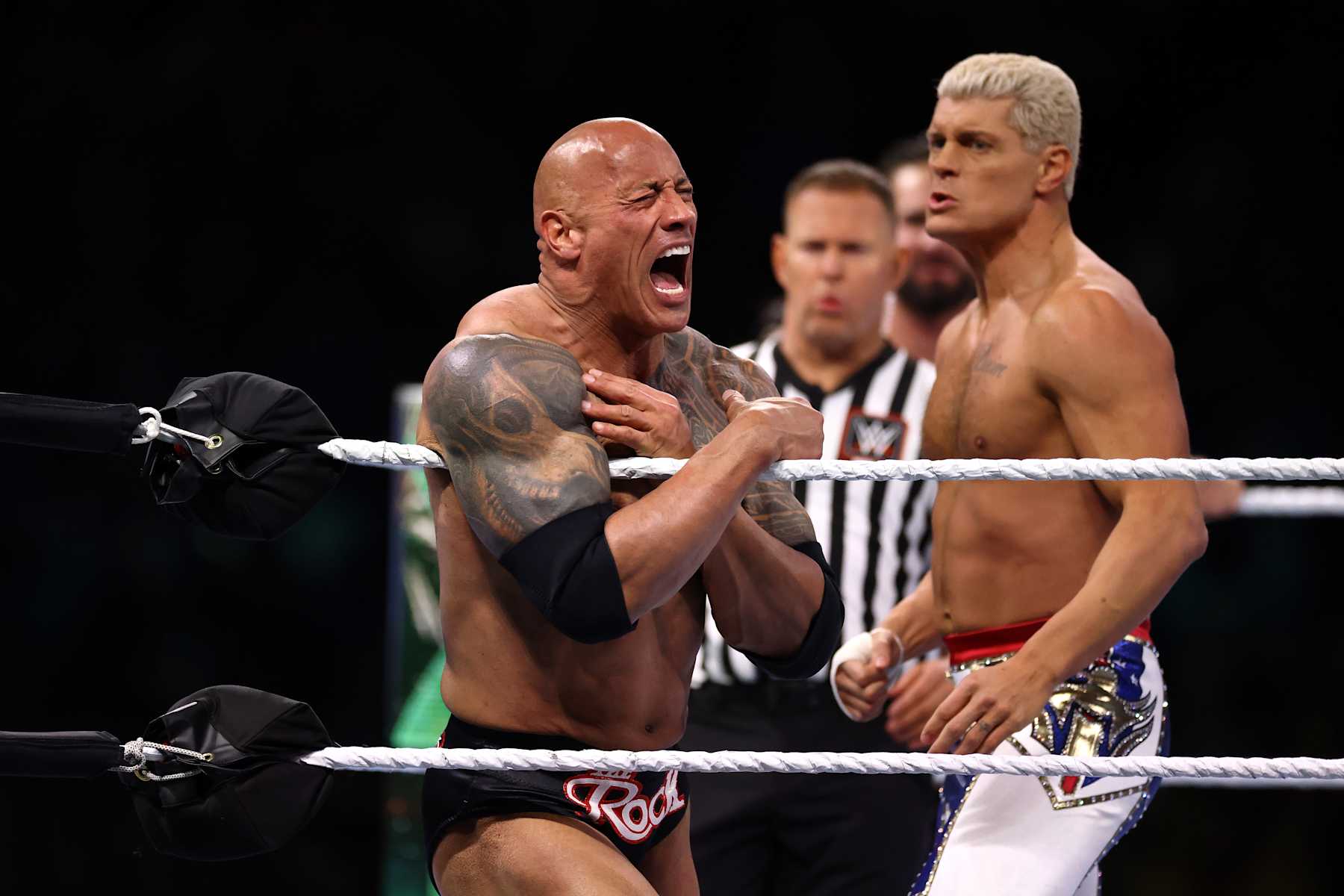 PHILADELPHIA, PENNSYLVANIA - APRIL 06: Dwayne "The Rock" Johnson reacts during a tag team fight with Romain Reigns against Cody Rhodes and Seth "Freakin" Rollins during Night One of WrestleMania 40 at Lincoln Financial Field on April 06, 2024 in Philadelphia, Pennsylvania.  (Photo by Tim Nwachukwu/Getty Images)