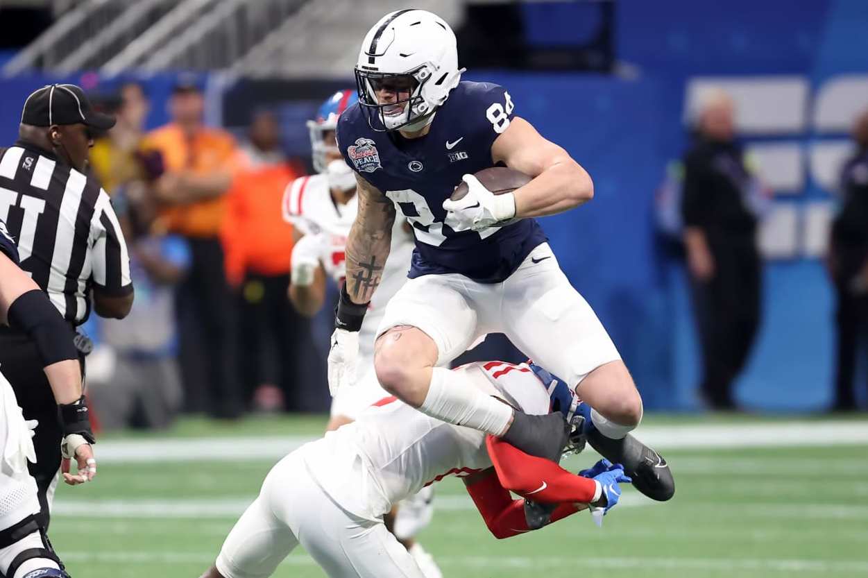 ATLANTA, GA - DECEMBER 30: Penn State Nittany Lions tight end Theo Johnson (84) leaps a defender during the Chick-fil-A Peach Bowl between the Penn State Nittany Lions and the Mississippi Rebels on December 30, 2023 at Mercedes-Benz Stadium in Atlanta, Georgia. (Photo by Michael Wade/Icon Sportswire via Getty Images)