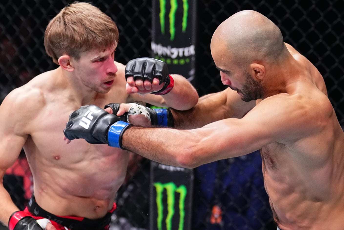 MANCHESTER, ENGLAND - JULY 27: (L-R) Arnold Allen of England punches Giga Chikadze of Georgia in a featherweight bout during the UFC 304 event at Co-op Live on July 27, 2024 in Manchester, England. (Photo by Chris Unger/Zuffa LLC via Getty Images)