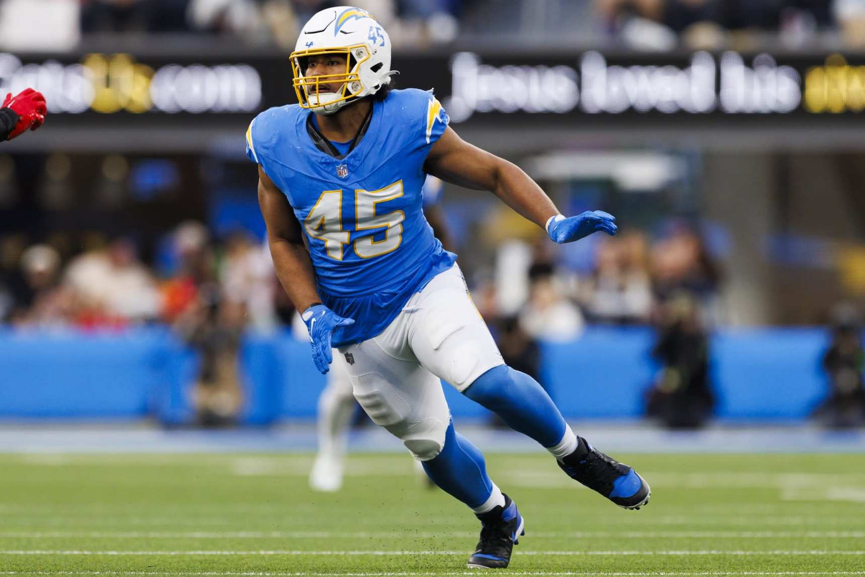 INGLEWOOD, CALIFORNIA - JANUARY 7: Tuli Tuipulotu #45 of the Los Angeles Chargers rushes the edge during a game against the Kansas City Chiefs at SoFi Stadium on January 7, 2024 in Inglewood, California. (Photo by Ric Tapia/Getty Images)