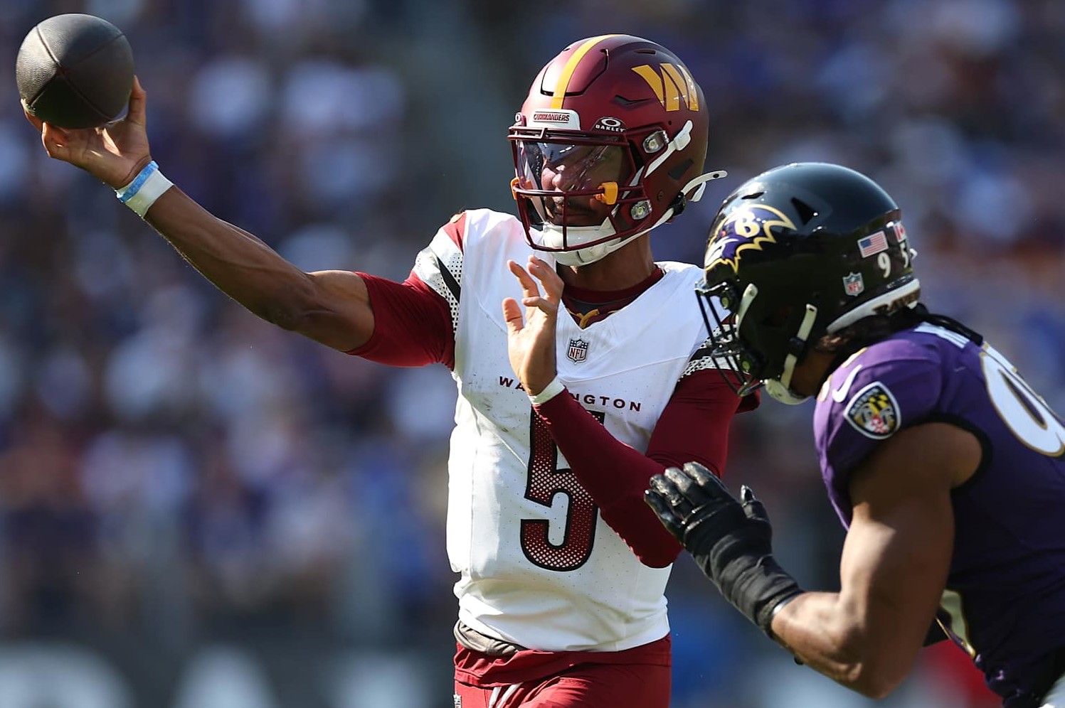 BALTIMORE, MARYLAND - OCTOBER 13: Jayden Daniels #5 of the Washington Commanders throws a pass against the Baltimore Ravens during the fourth quarter at M&T Bank Stadium on October 13, 2024 in Baltimore, Maryland. (Photo by Rob Carr/Getty Images)